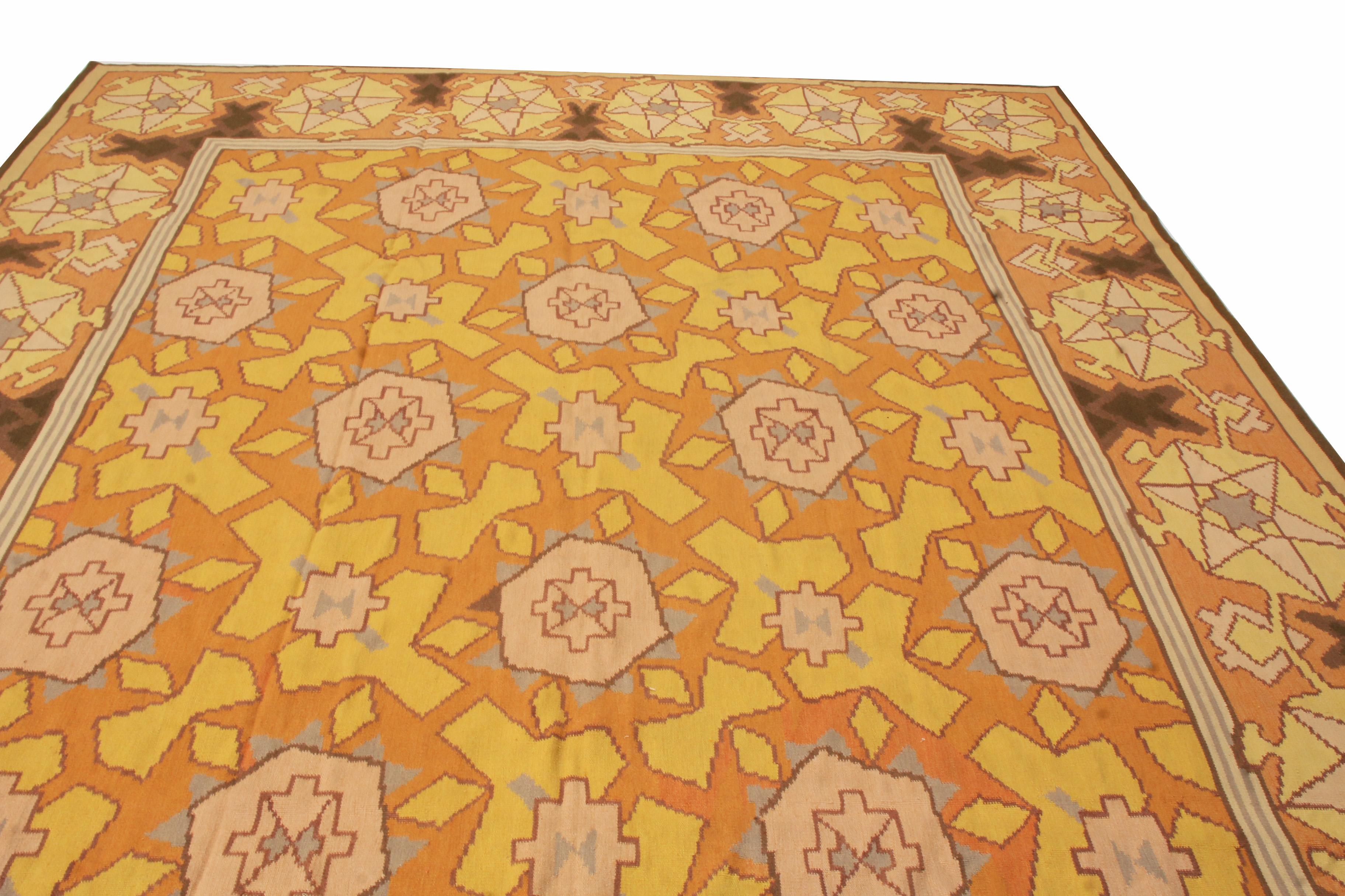 Originating from Romania, this contemporary rug is hand knotted in fine, high quality wool with highly stylized geometric imagery. The field design, set against a rustic sunset orange background, depicts a series of pink and yellow geometric symbols
