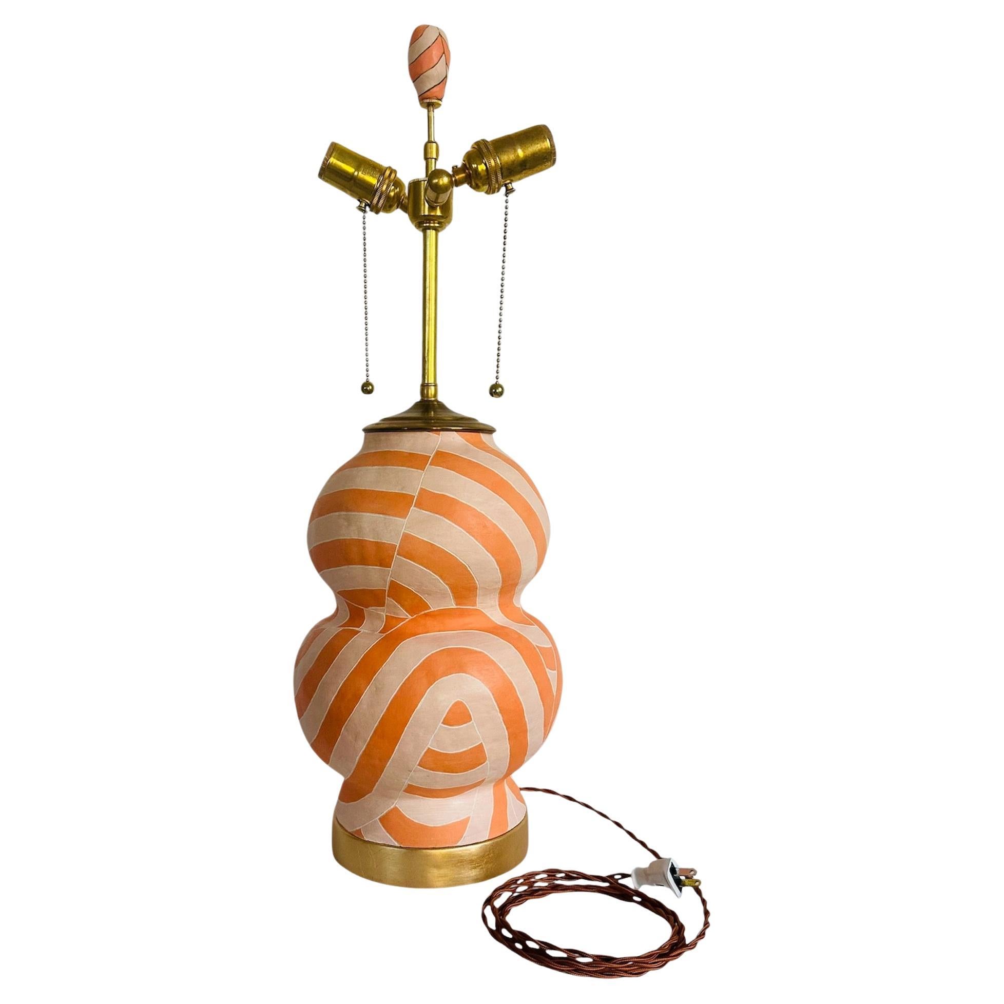 Contemporary geometric patterned lamp in orange and peach