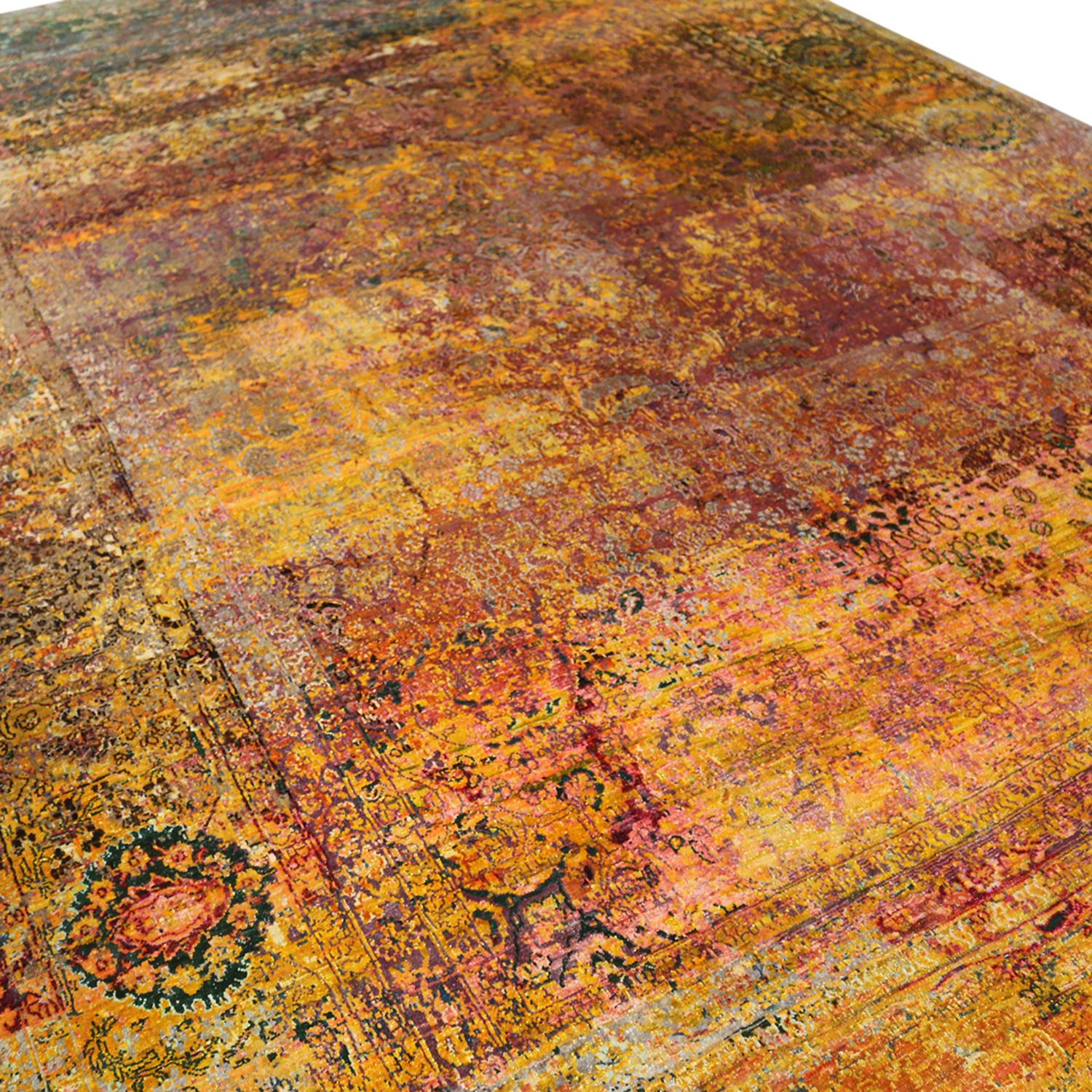 Hand knotted in high-quality luminous silk originating from India this contemporary rug enjoys a unique distressed aesthetic inspired by antique Agra masterpieces, marrying elements of each to achieve this blend of the pomegranate pink-red and gold