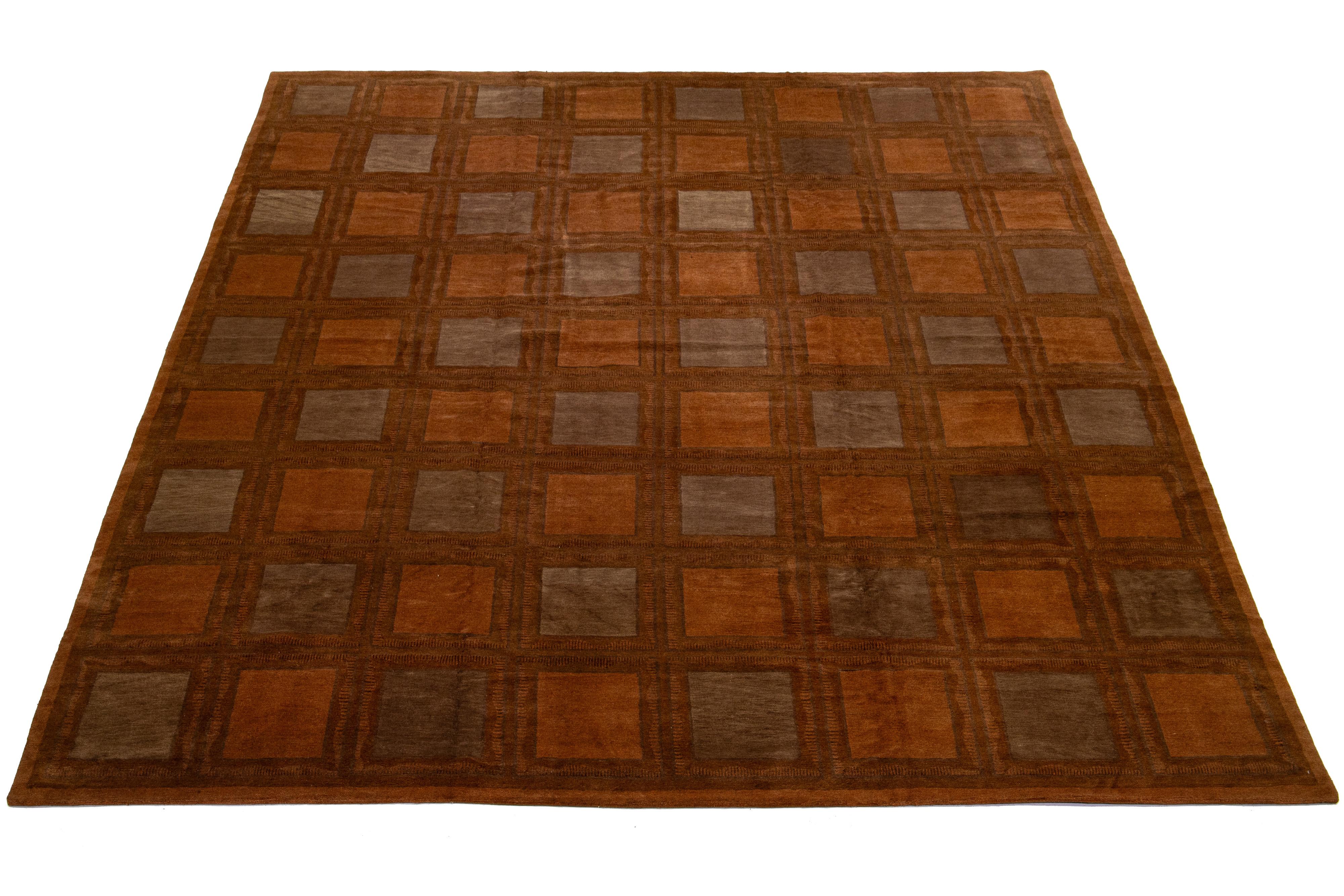 This contemporary Tibetan rug showcases a bold orange hue complemented by subtle brown details, resulting in a sleek and elegant geometric design that captures the spirit of modernism in the 21st century.

This rug measures 13'2