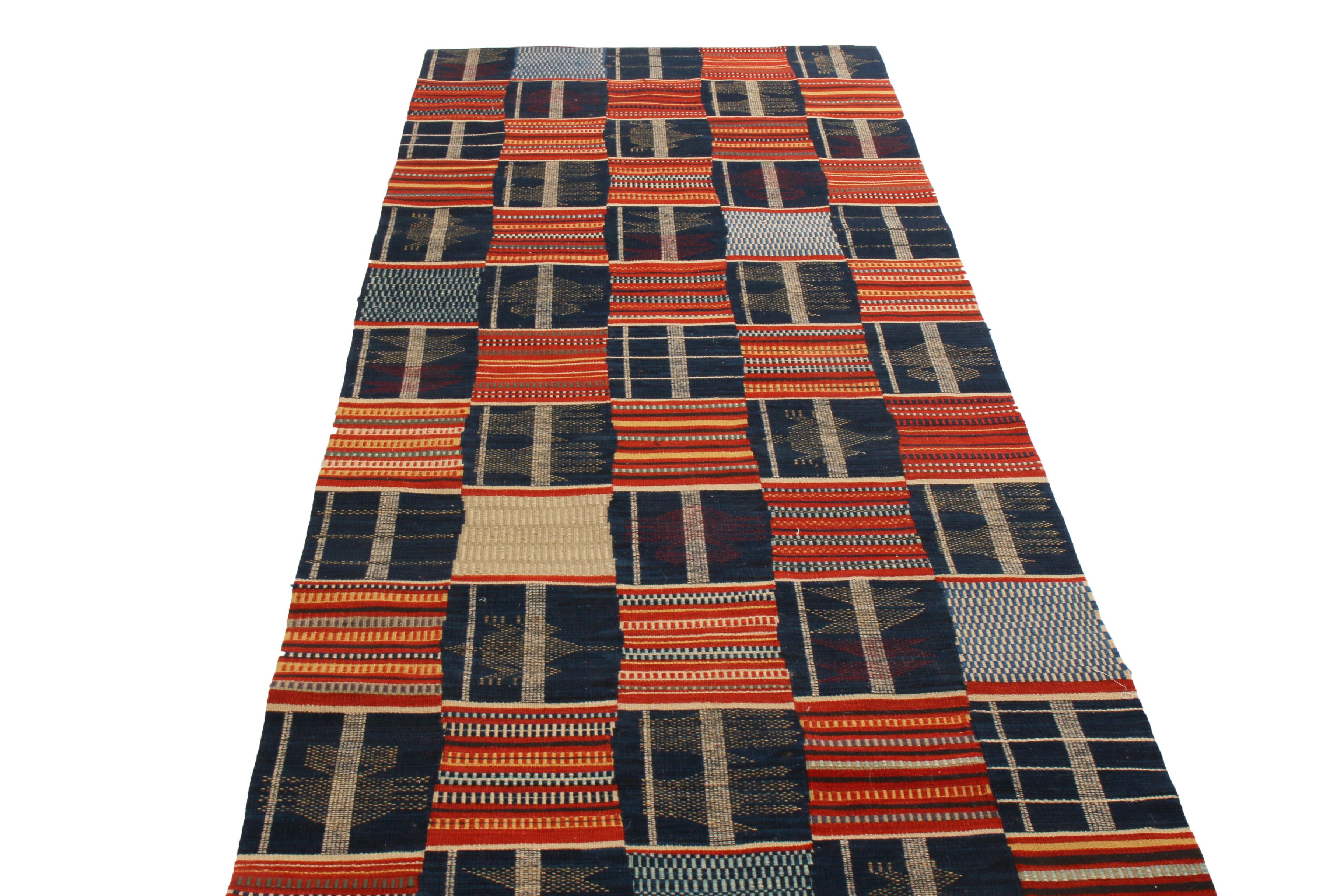 Originating from China, this contemporary runner is hand knotted with durable, high quality wool depicting a patchwork Ghana design, featuring an array of protective hand and medallion motifs in rich navy blue, grey, and red tribal colorways.
 