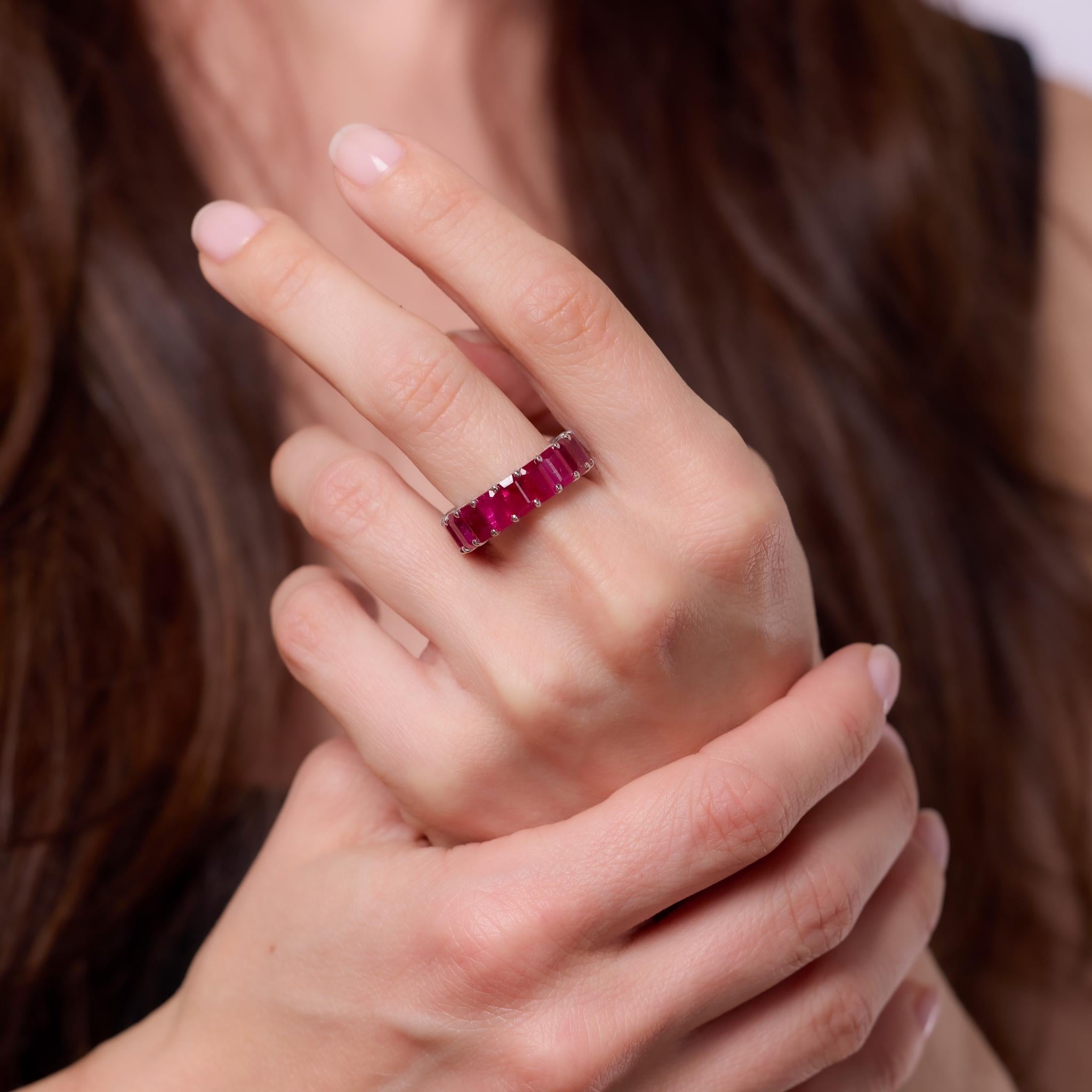 Crafted in the 2010s, this contemporary band features 18 GIA-certified emerald cut rubies from Burma, totaling approximately 8.15 carats. Treated with heat to enhance their vivid red hue, the rubies are set in a continuous line of brilliance within