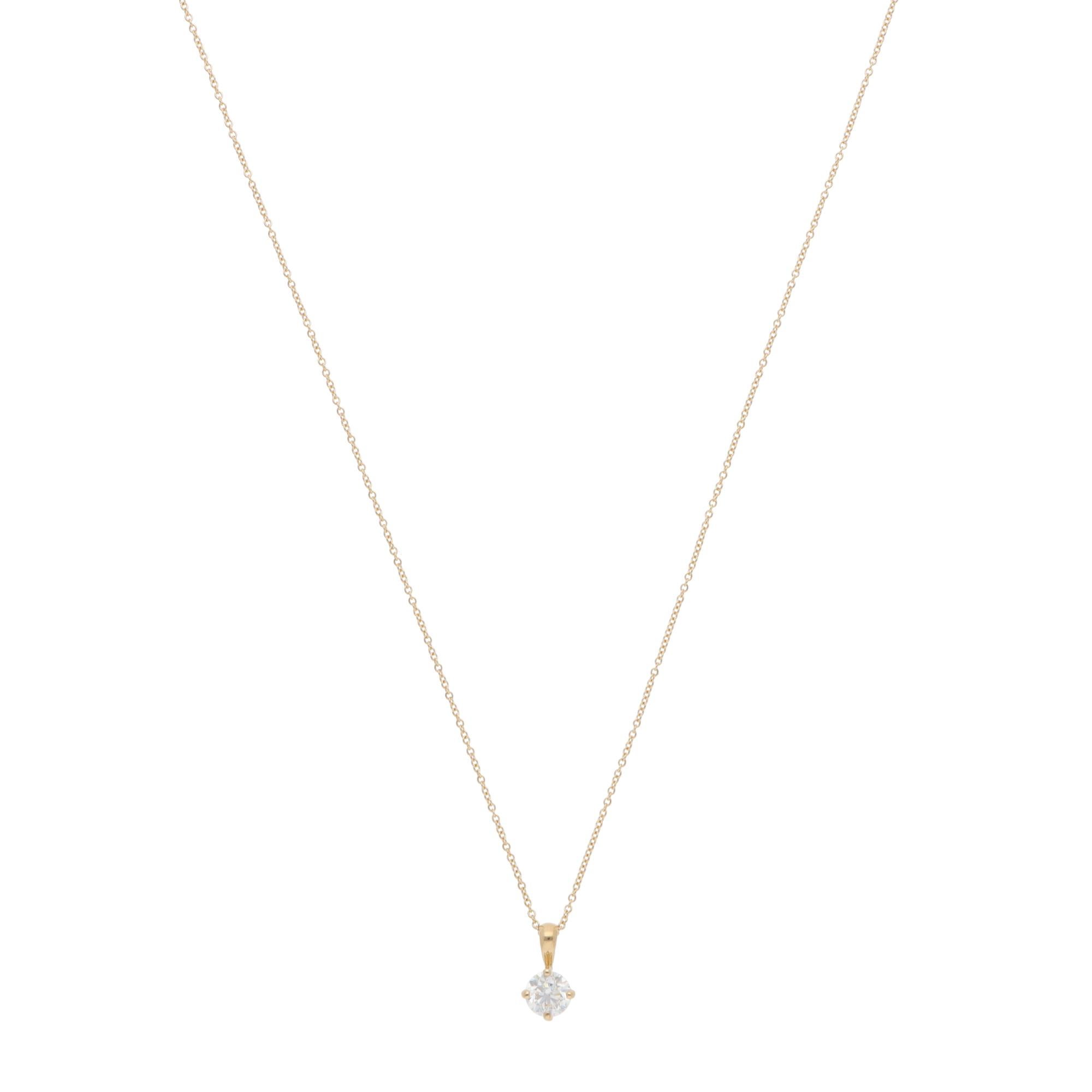 A beautiful contemporary diamond solitaire pendant necklace set in 18k yellow gold.

The necklace solely features a spectacular round brilliant-cut diamond, which is securely set in a four-prong open gallery setting. The true beauty of this piece