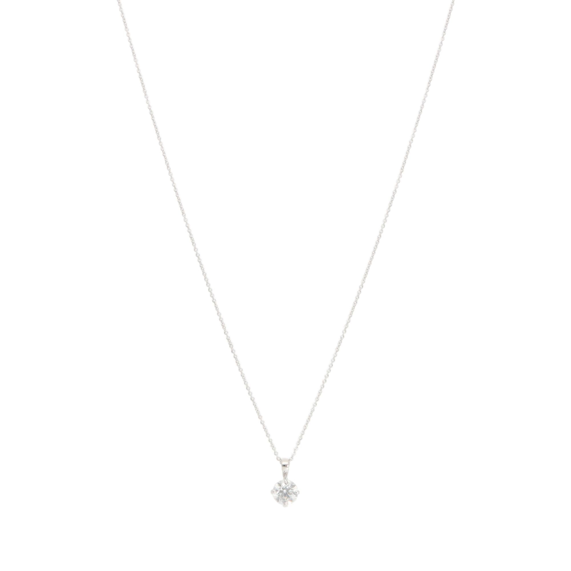 A beautiful contemporary diamond solitaire pendant necklace set in 18k white gold.

The necklace solely features a spectacular round brilliant-cut diamond, which is securely set in a four-prong open gallery setting. The true beauty of this piece all