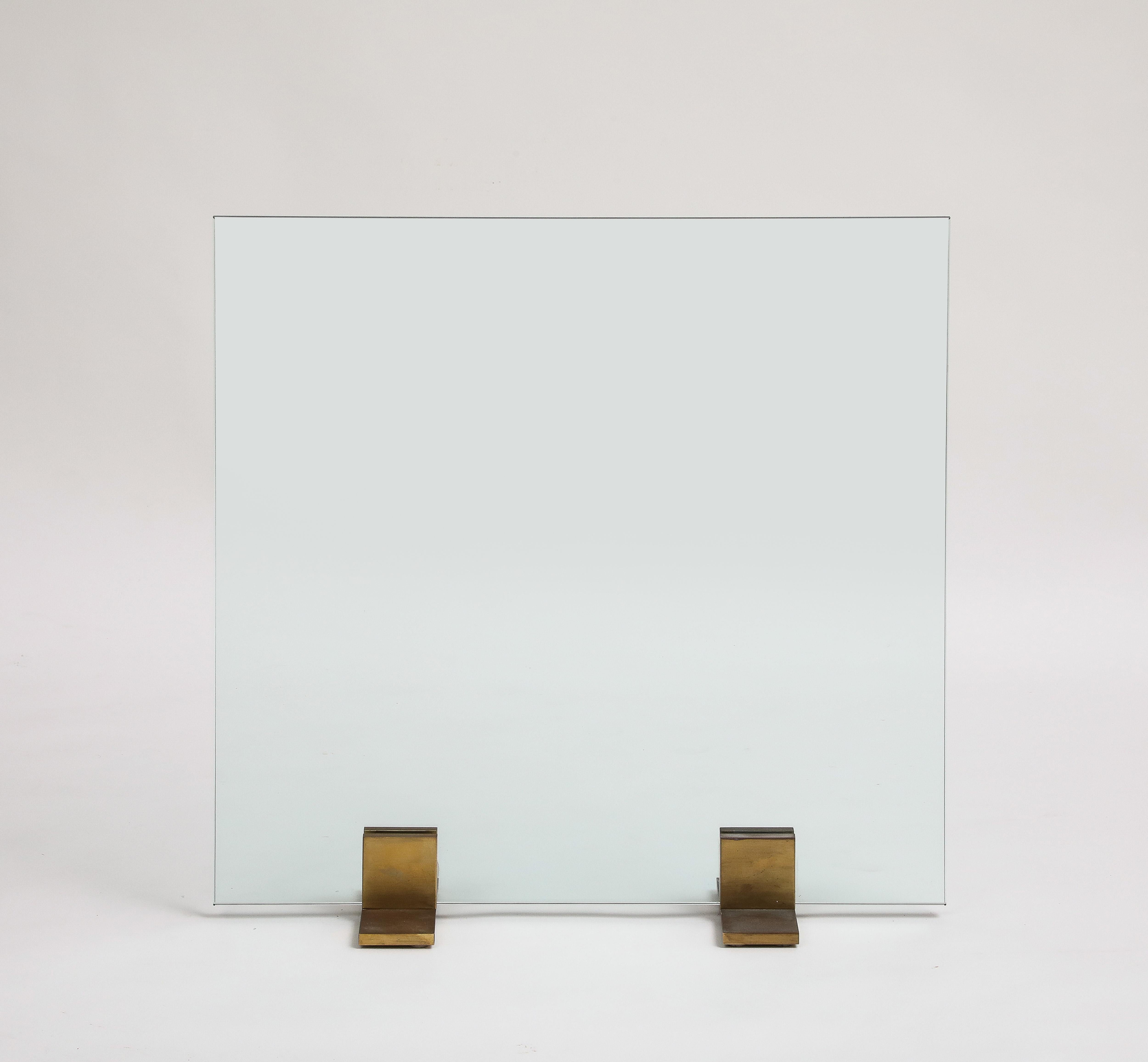 Contemporary glass firescreen with bronze feet. Sleek, minimalist look. 