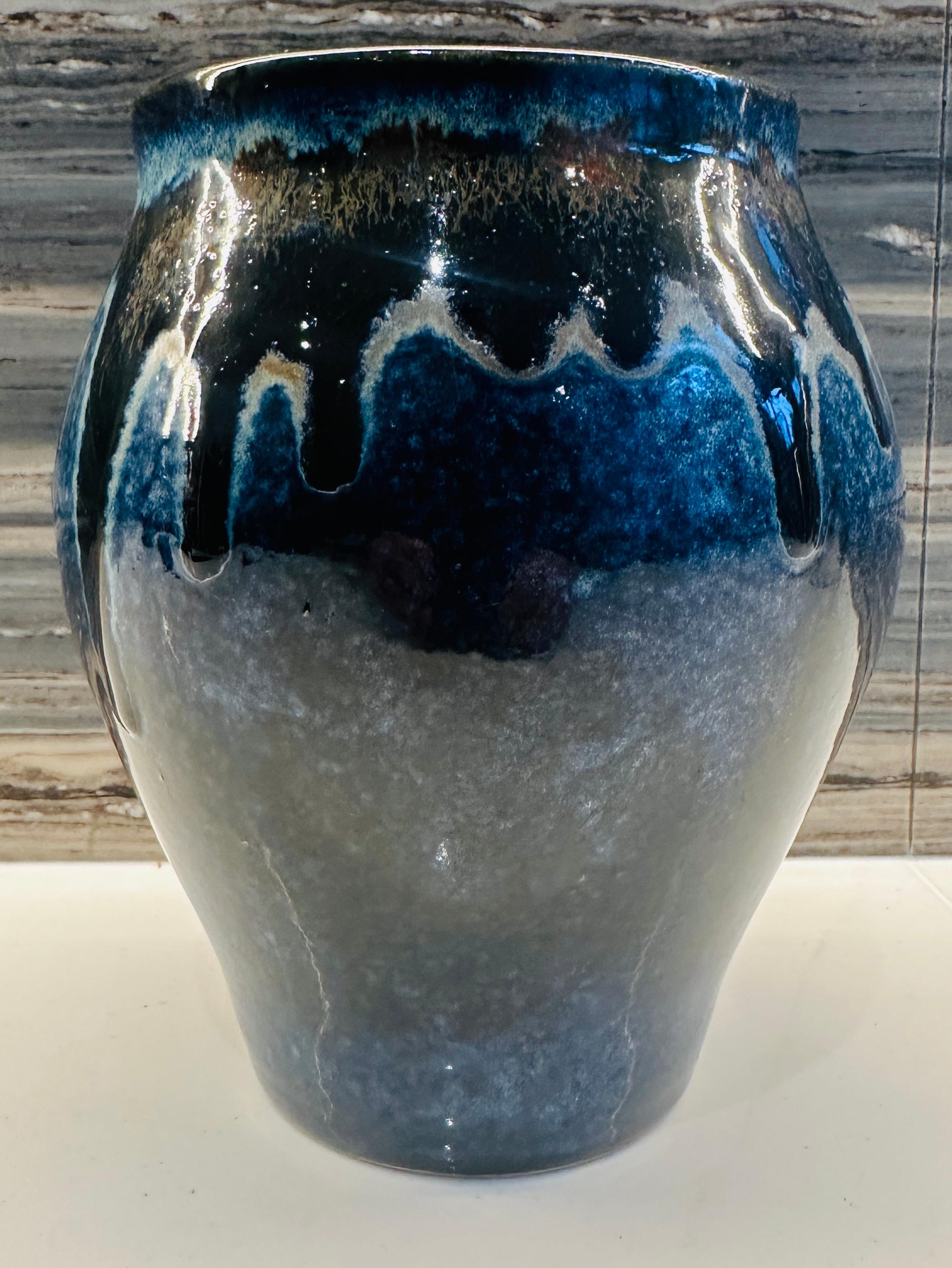 No 30.  Contemporary handmade mottled blue rustic ceramic glazed vase with a molten blue and metallic gold drip design around the rim and interior. Designed and made by Brazilian ceramicist Flavio Diogo of FD21 Clay.

Dimensions: Diameter: 14cm
