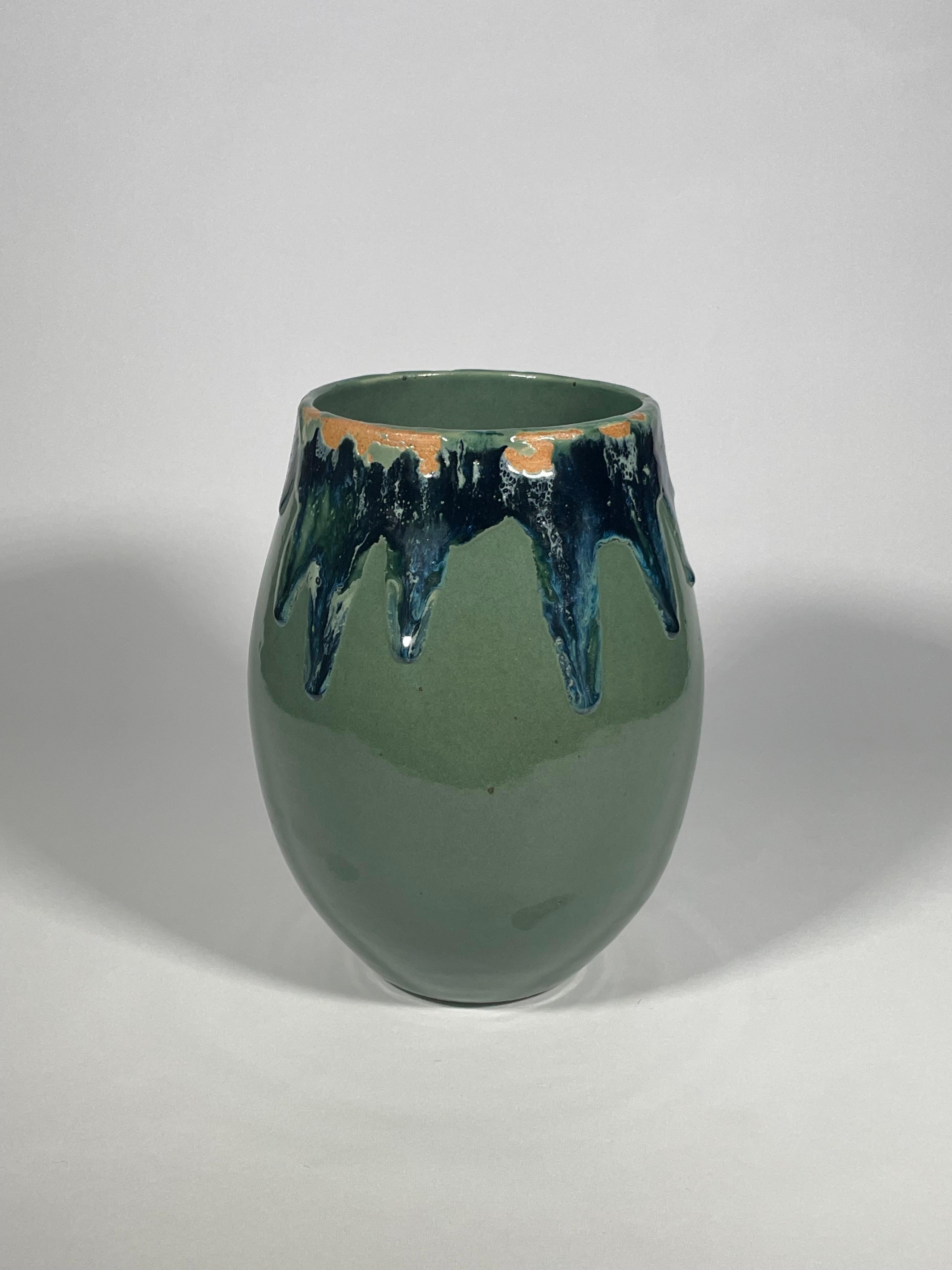 No 29.  Contemporary handmade blue green rustic ceramic glazed vase with a molten design around the rim with the clay exposed in places beneath. Designed and made by Brazilian ceramicist Flavio Diego of FD Clay.

Dimensions: Diameter: 18cm Height: