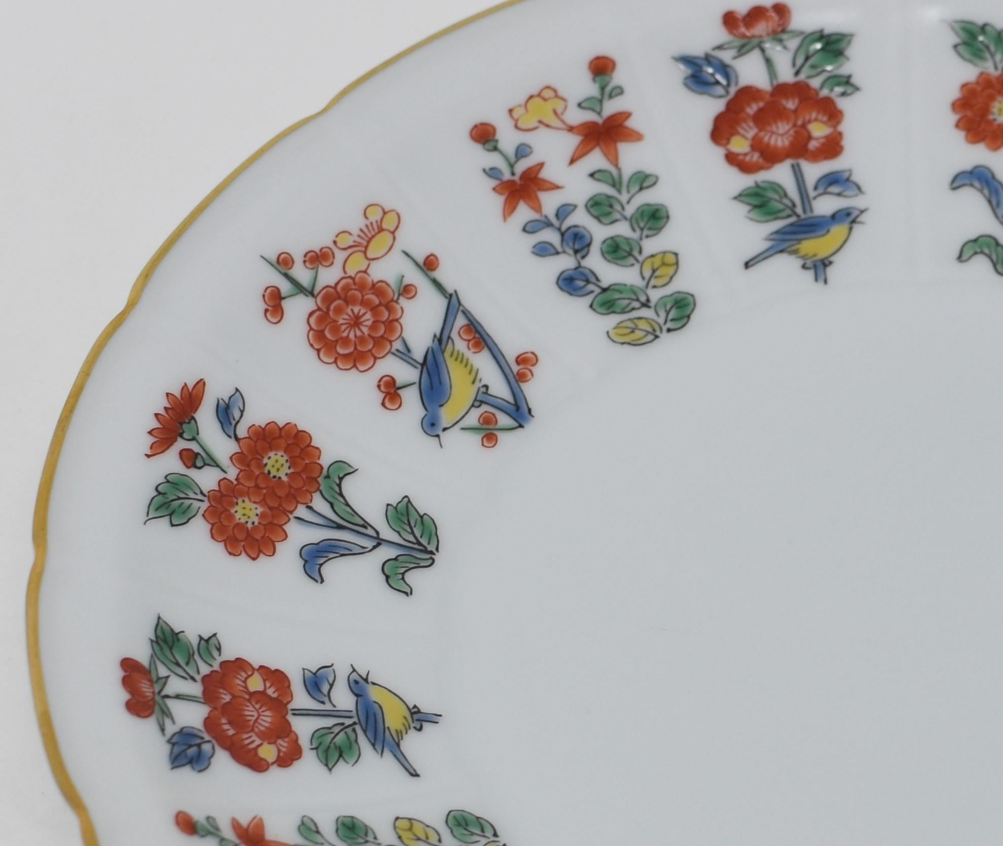 Exquisite contemporary Japnese gilded hand painted Porcelain dessert plate in vivid red, blue and green generously decorated with gold, with an intricate flower and gold pattern. The pattern of this stunning set, scalloped around the rim of the cup
