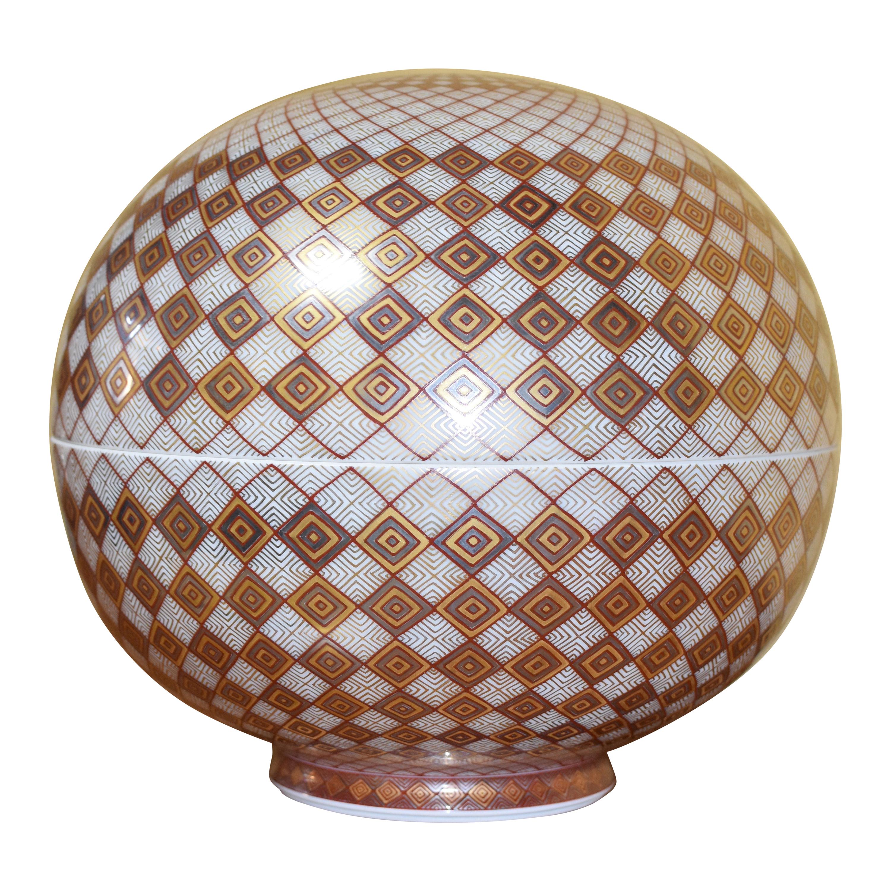 Extraordinary Japanese contemporary decorative porcelain box, extremely intricately hand-painted in cream and red and gilded in platinum and gold, on an exquisite globular body in cream, featuring an extremely intricate geometric progression