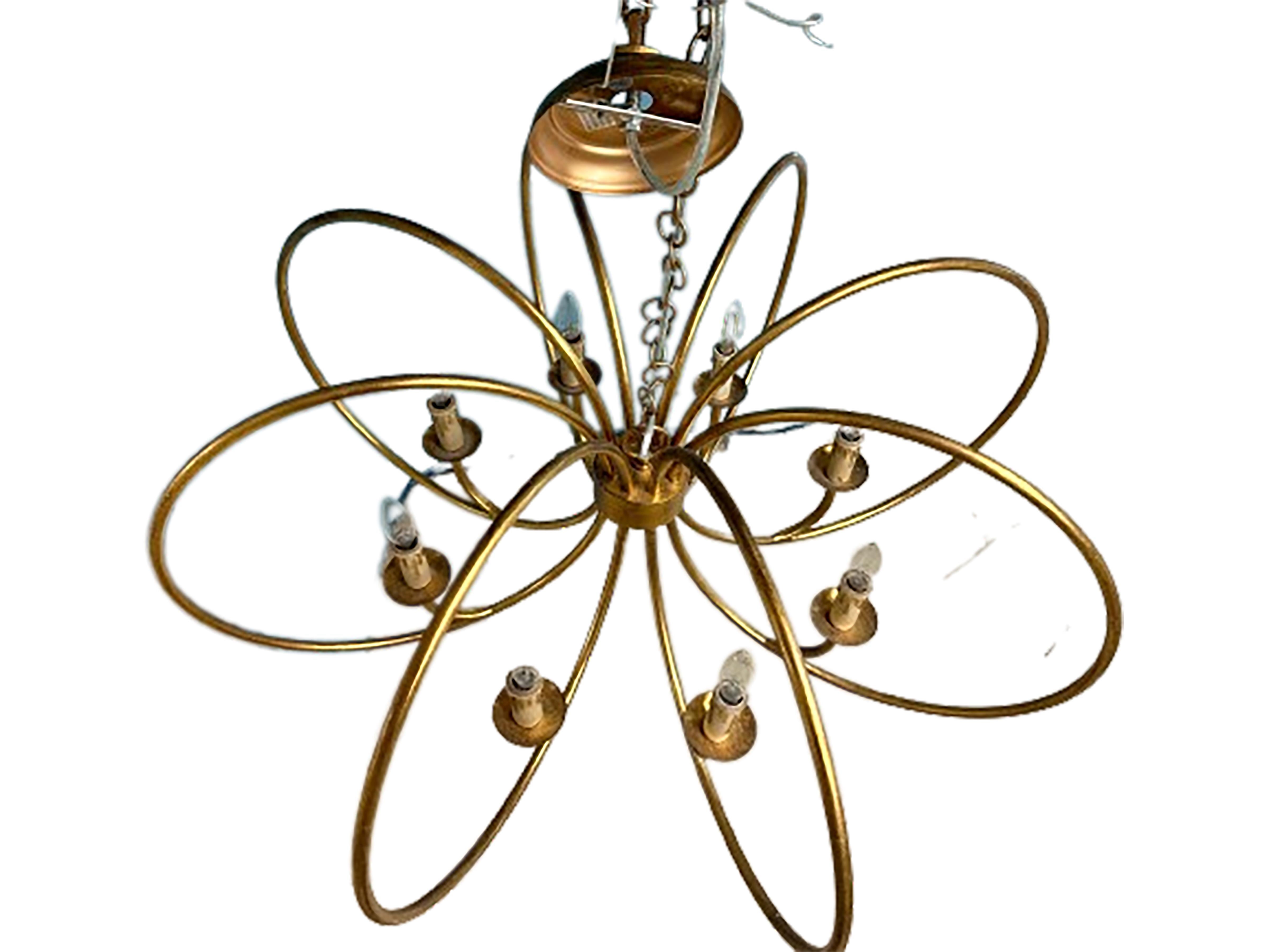 A handsome contemporary handmade golden ring pattern chandelier. Made of painted gold metal. Created during the 21st century. Hand gilt. Wired for electric lighting. 

In very good condition.  

No obvious markings on the piece. 

Would make a great
