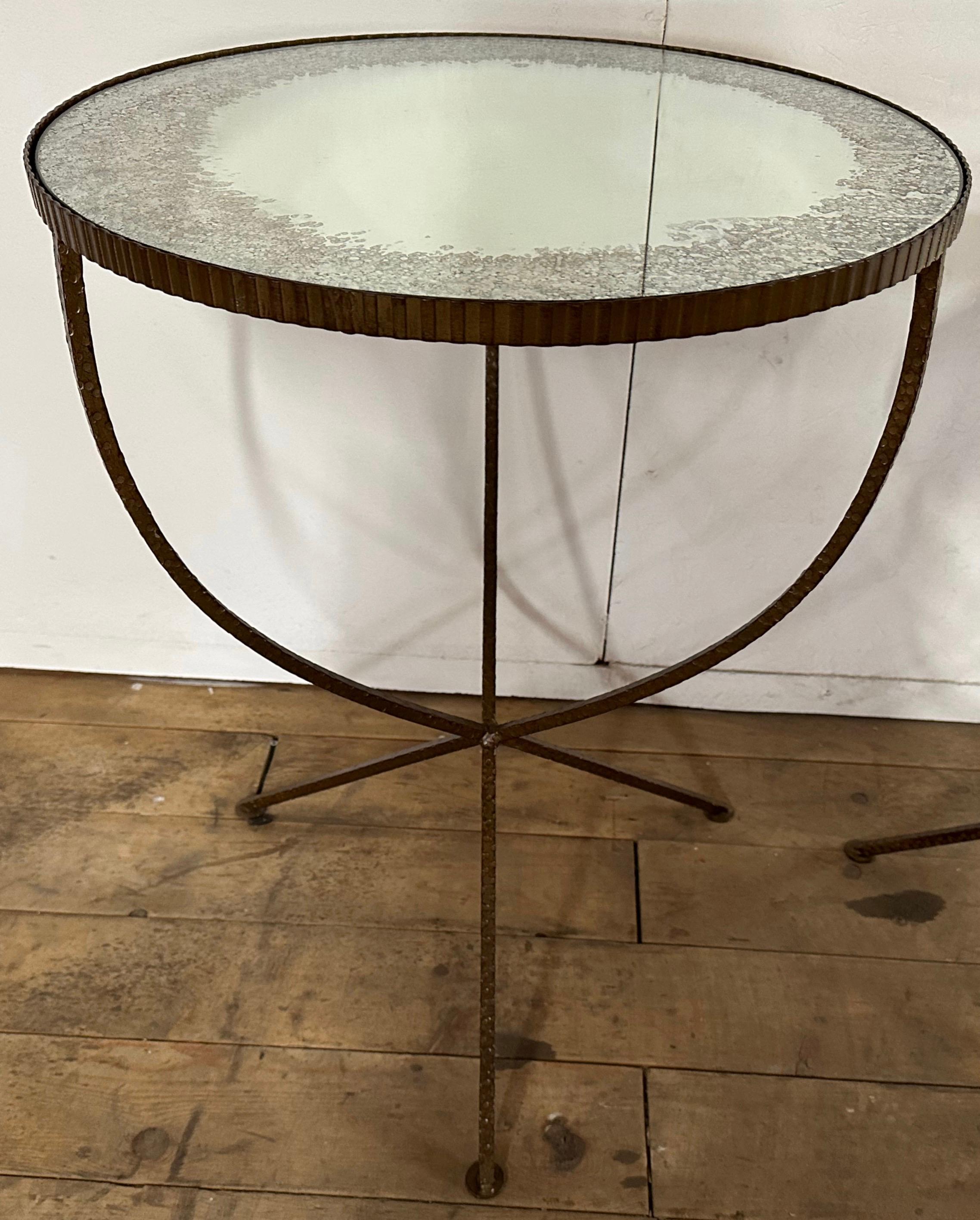 The Mid-Century Modern Round gold toned table has a hammered textured iron frame with antiqued mirror to give it character. This side, end table or accent table has the elegance in the manner of an Hollywood Regency or neoclassical table.
The table