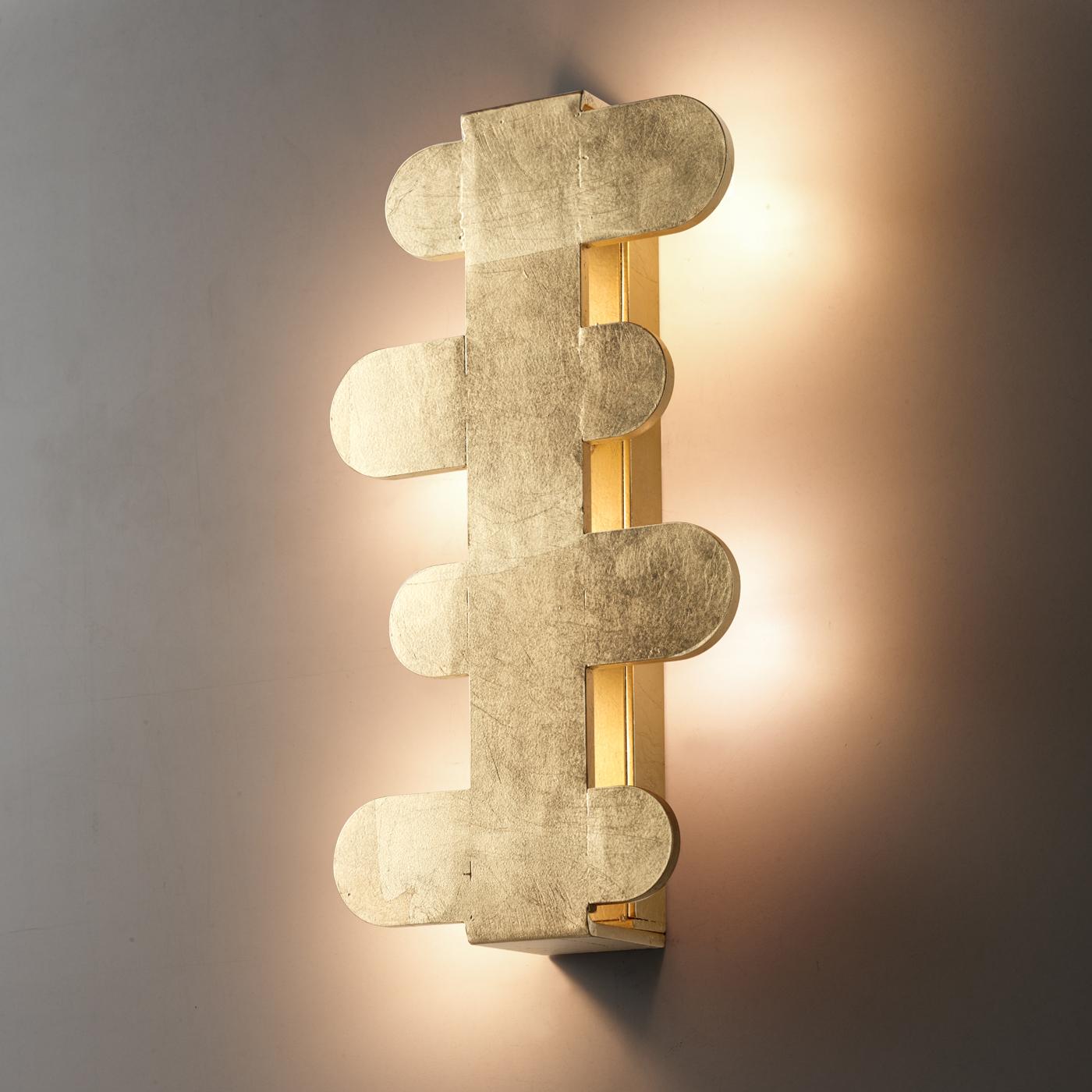 Merging the preciousness of gold leaf and markedly contemporary design, this one-off wall lamp would be a superb addition to luxe contemporary interiors. The metal frame enriched by a gold-leaf coating comprises four horizontal, elliptical elements