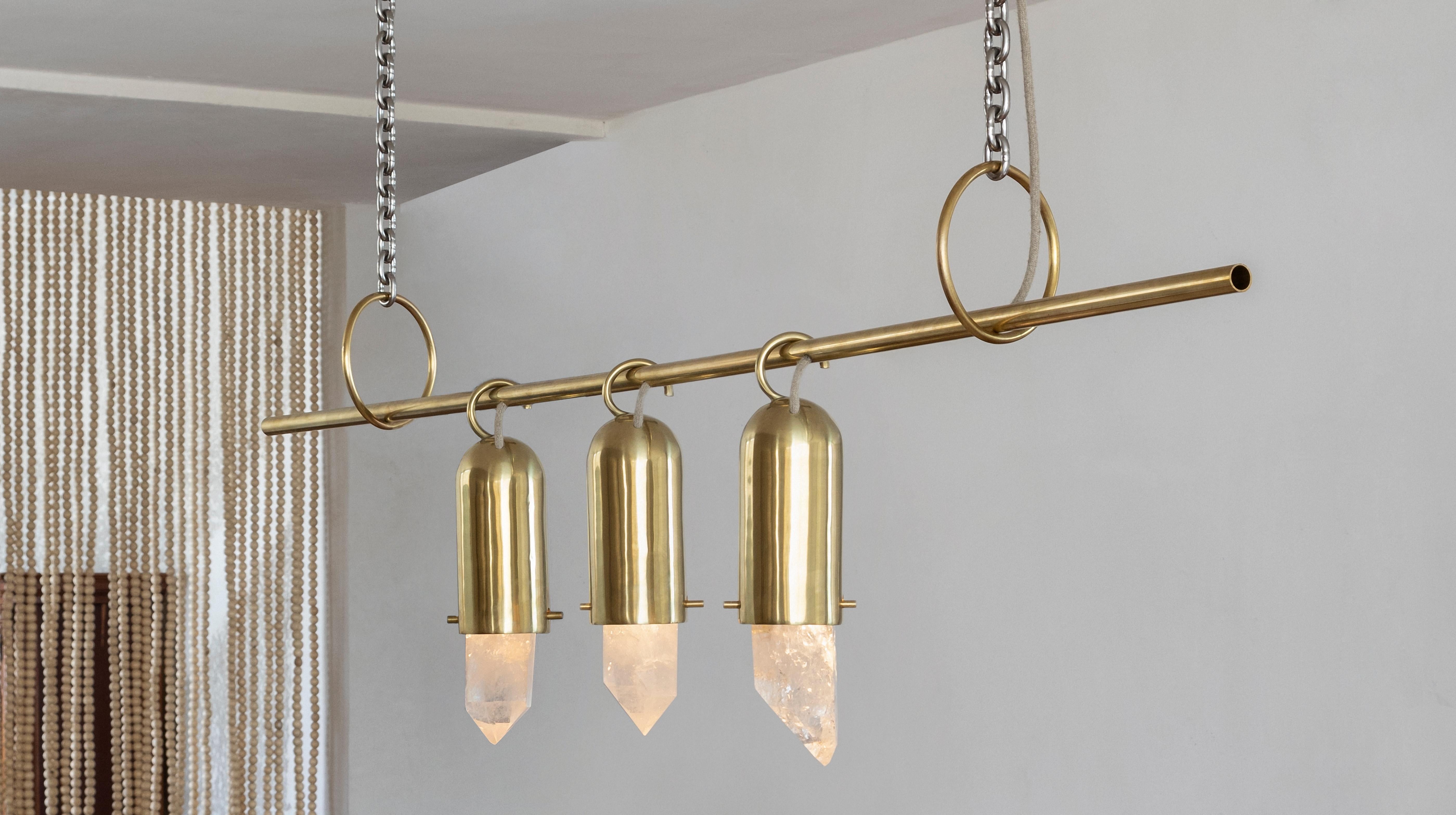 Contemporary golden chandelier, in cast brass and illuminated raw crystal.
Produced in São Paulo, Brazil.

This chandelier was meticulously handmade by master artisans one delicate piece at a time. It is therefore quite difficult, if not impossible