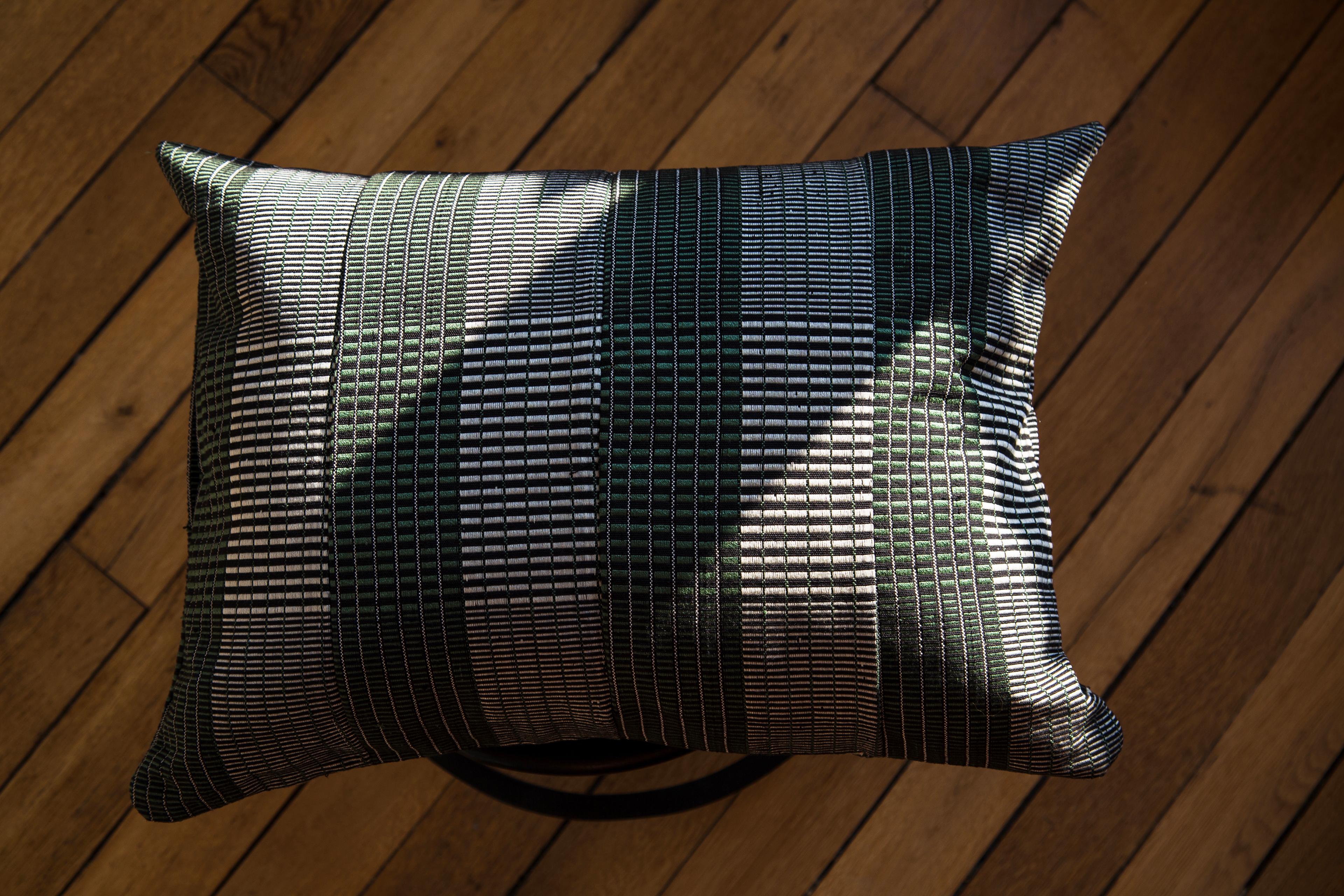 Woven Kente cushion 2-Step: 
Naturally graphic
Colours: Herb

There is something very comforting about the natural tones of soft green, don’t you think? This graphic cushions in Green, black and off-white plays with contemporary pattern with a