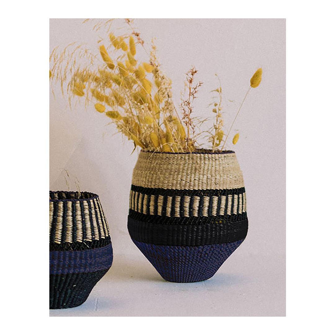 Woven vase Pin Stripe Small: 
Elegant Vase
Colours: Natural and Black punctuated by an Indigo (inky blue) Stripe

Are you looking for unexpected objects to decorate your home? This small vase is delicately woven and will be a funky element in