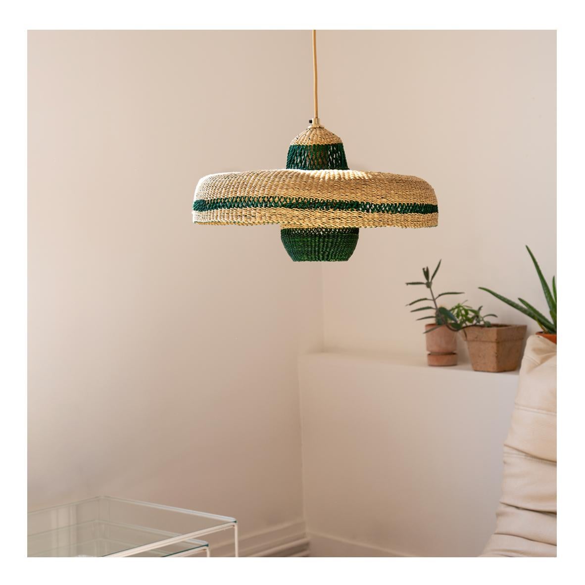 Woven Pendant Lamp HATTER + LANTERN: 
Dynamic and natural
Colour: Natural and Herb (Bottle Green)

Are you looking for a unique lamp that marries artisan and design? This sculptural lamp gives artisanat an arty twist with it´s two shapes a flat