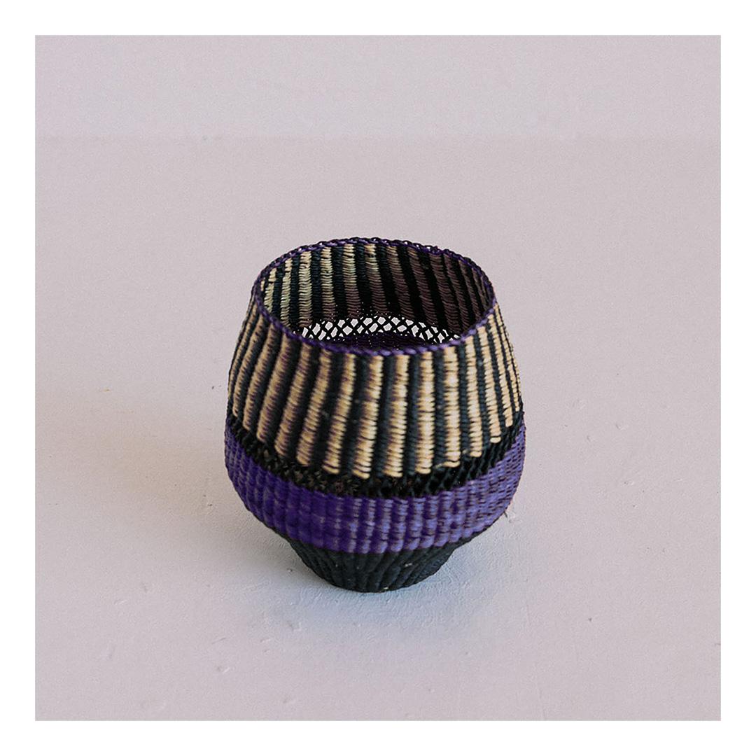 Woven vase Pin Stripe Small: 
Funky Vase
Colours: Natural and Black punctuated by an Indigo (inky blue) Stripe

Are you looking for unexpected objects to decorate your home? This small vase is delicately woven and will be a funky element in your