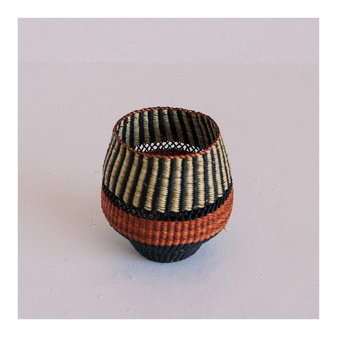 Woven vase Pin Stripe Small: 
An Elegant Receptacle
Colours: Natural and Black punctuated by a Ginger (terracotta) Stripe

Are you looking for a chic woven object to adorn your home? This striped small vase is carefully woven and will be an eye