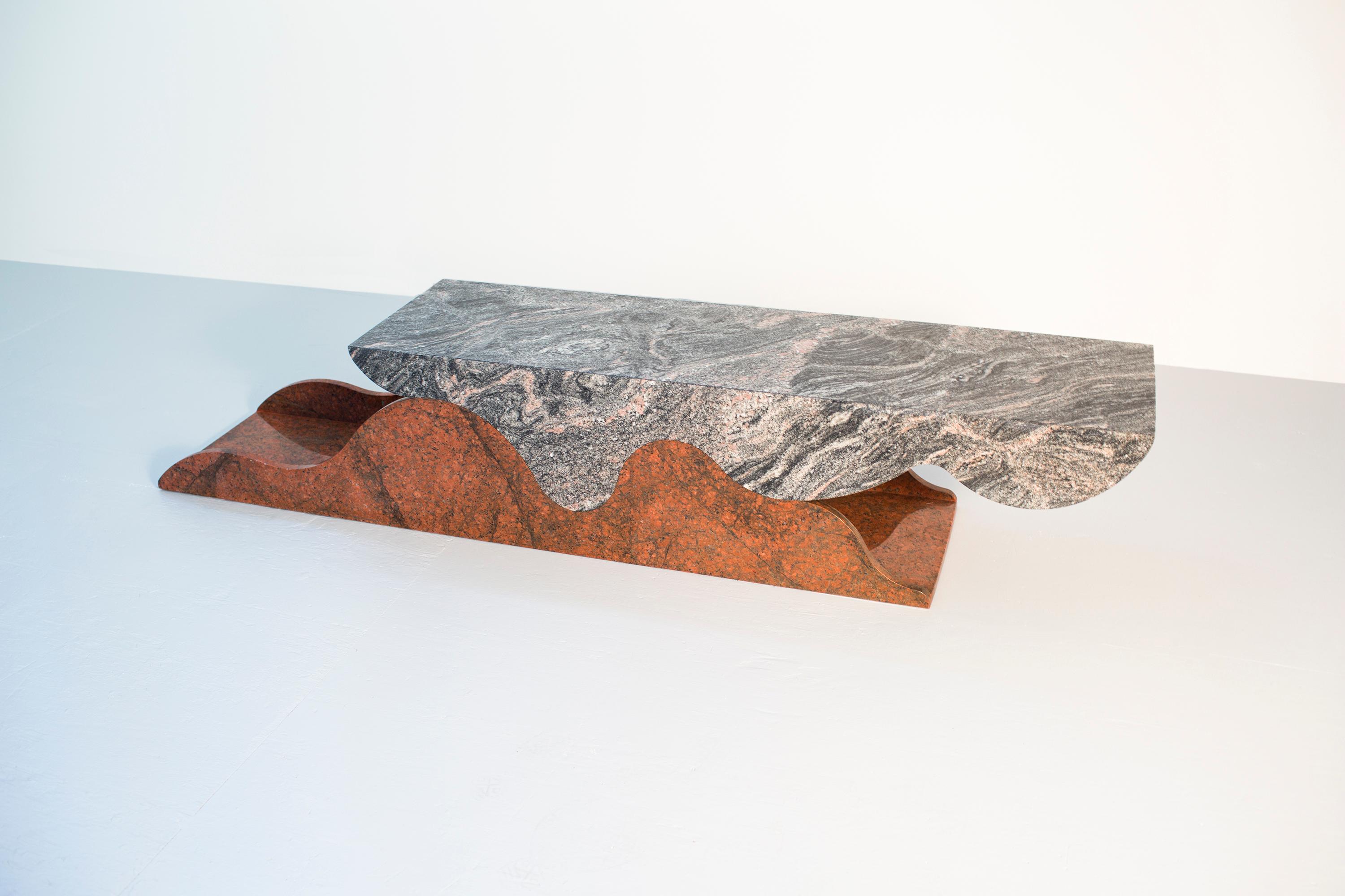 The Gaspar table is 2 pieces of granite formed to join each other, creating a surface at coffee table or console height.

The interior of the table can be used to store items like magazines or various display materials.

The top of the table surface