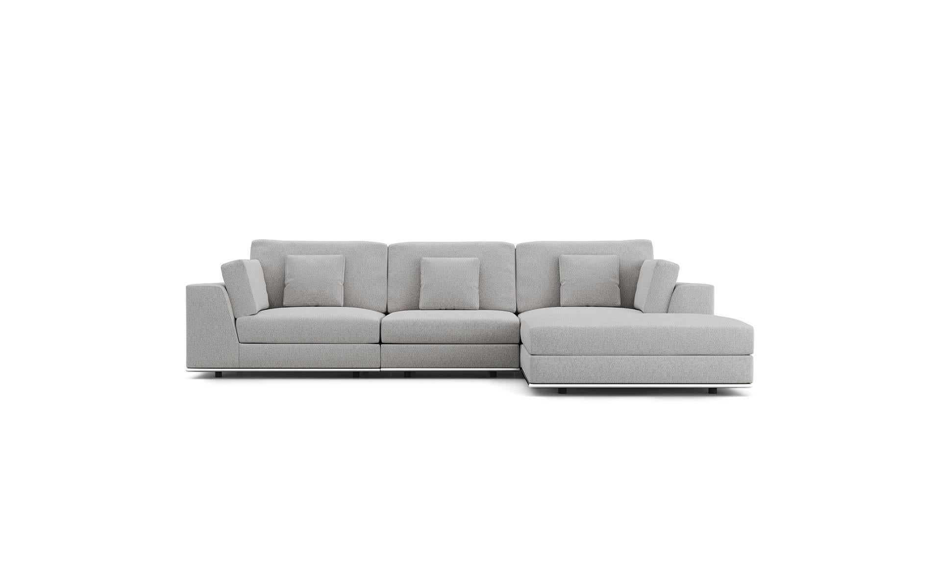 A contemporary light grey couch that can be configured many different ways: as a three seat sofa, two-seat settee, sectional couch with one chaise, with two chaises, sofa with an ottoman as coffee table, etc. The fabric is soft and very pleasant to