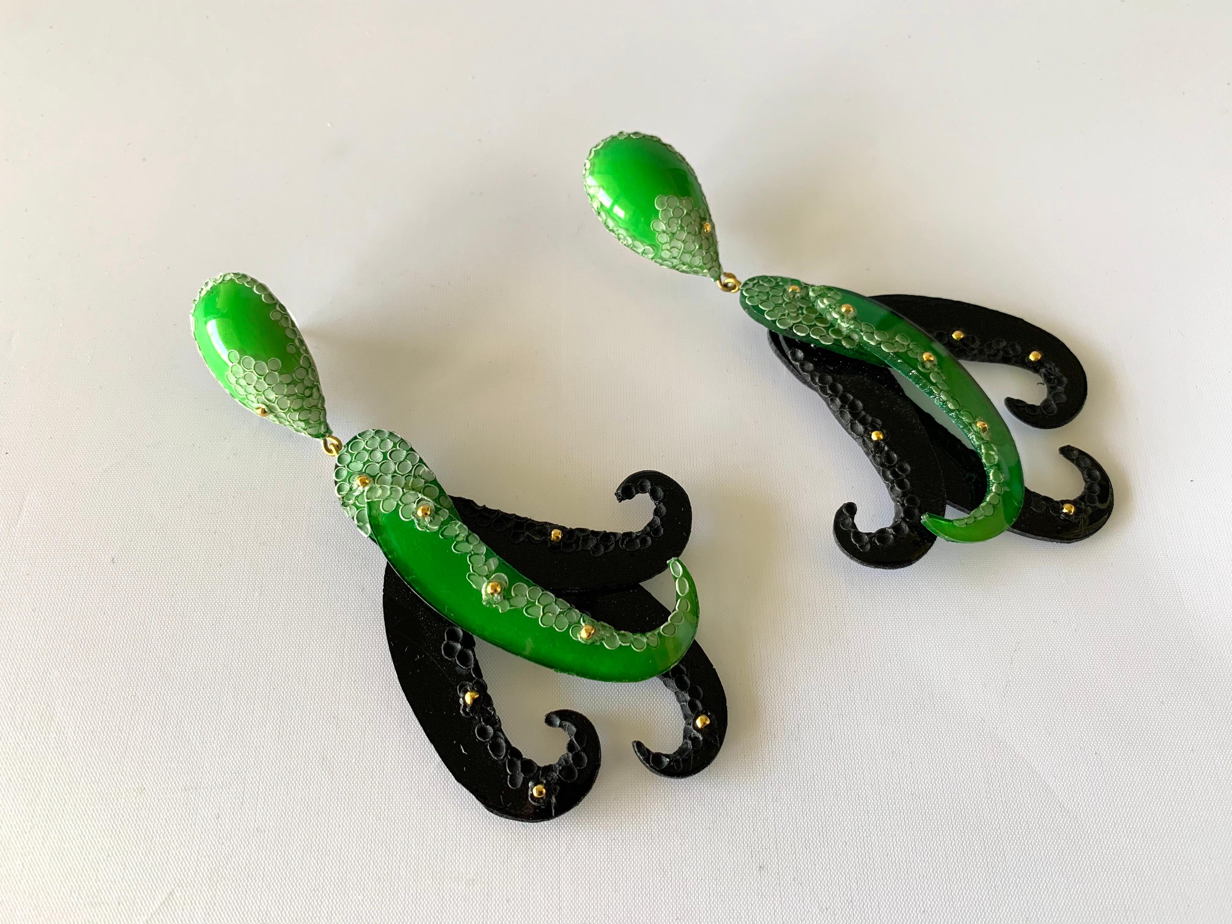 Light and easy to wear, these handmade artisanal statement earrings were made in Paris by Cilea. The lightweight earrings feature giant sea creature tentacles, comprised out of enamel and resin in black and green. A unique pair of well-crafted