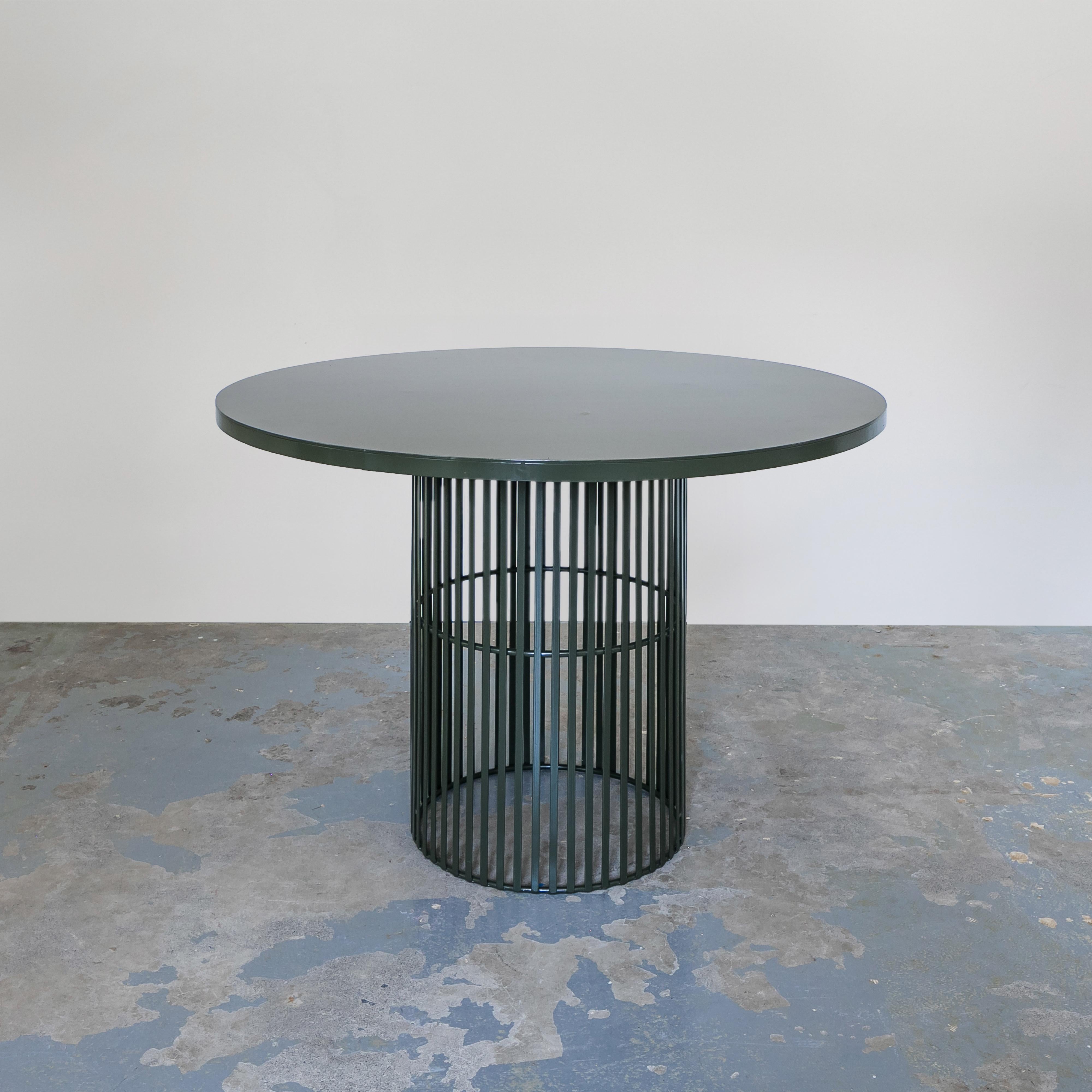Green Contemporary Metal Garden Dining Set with 4 Dining Chairs. The powder coated slated metal structure makes this suitable for the outdoors.  The minimalist profile of this set with rounded lines makes it modern and sculptural. The chairs are