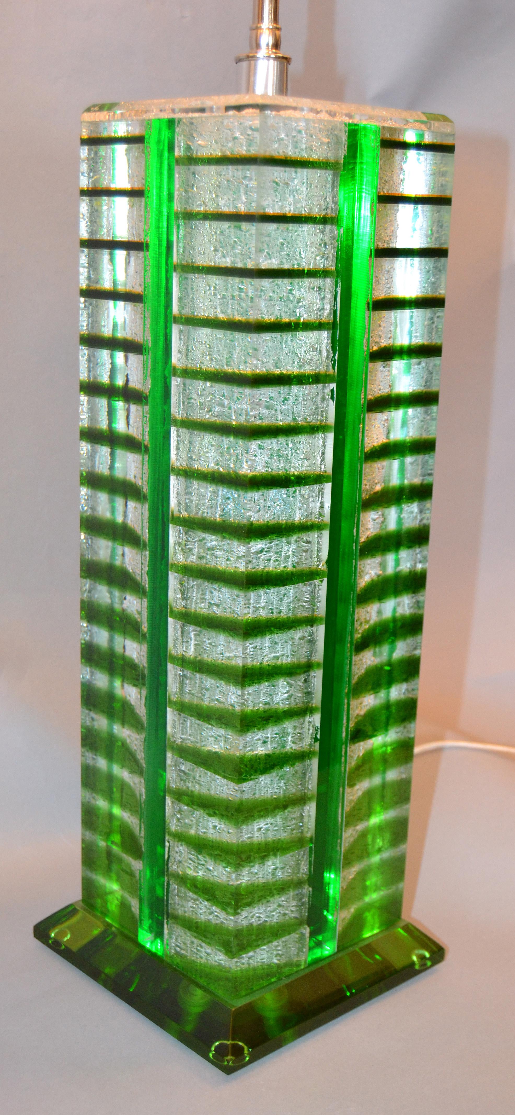 A pair of architectural shaped table lamps in green, white and transparent Lucite pieces.
They come with a unique matching rectangular shade in acrylic.
The lamp holders are made out of nickel with expandable double cluster sockets and pull