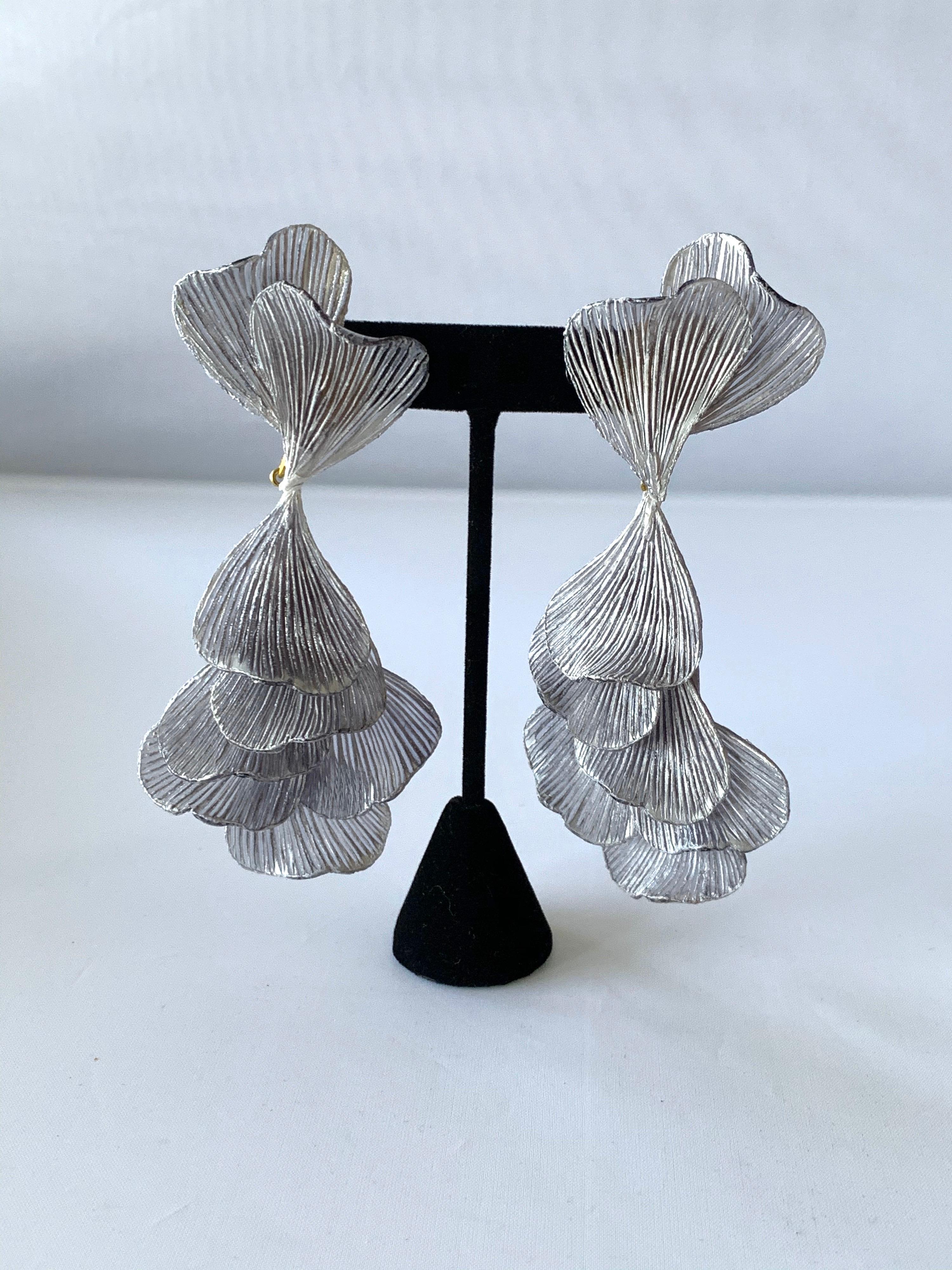 Light and easy to wear, these handmade artisanal clip-on earrings were made in Paris by Cilea. The lightweight clip-on earrings feature molded wave segments of enameline (enamel and resin composite) in grey, almost resembling whimsical fishtails.