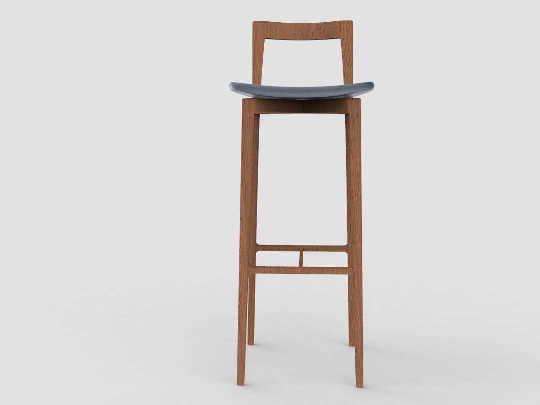 Contemporary Grey Bar Chair in Linea 624 Azzurro Leather & Smoked Oak by Collector Studio

With a light solid wood structure, this bar chair is suitable for contemporary interiors, the bar chair’s proportions and reduction of material provides