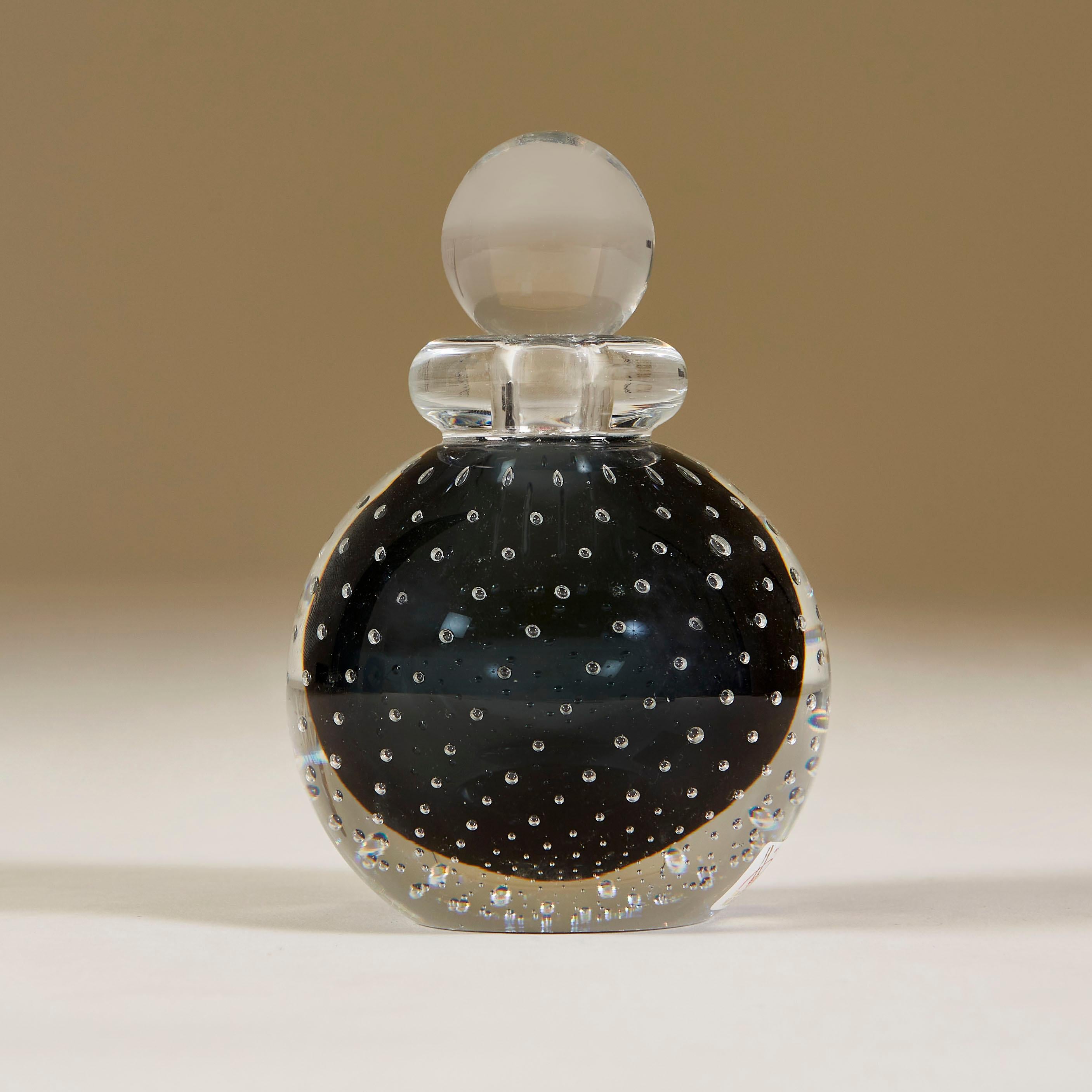 Rich red Bullicante ball perfume bottle cased in clear Murano glass with clear glass collar and ball stopper.

Made famous in the 1930s by Archimede Seguso, the Bullicante controlled bubbles technique involves overlaying several layers of air