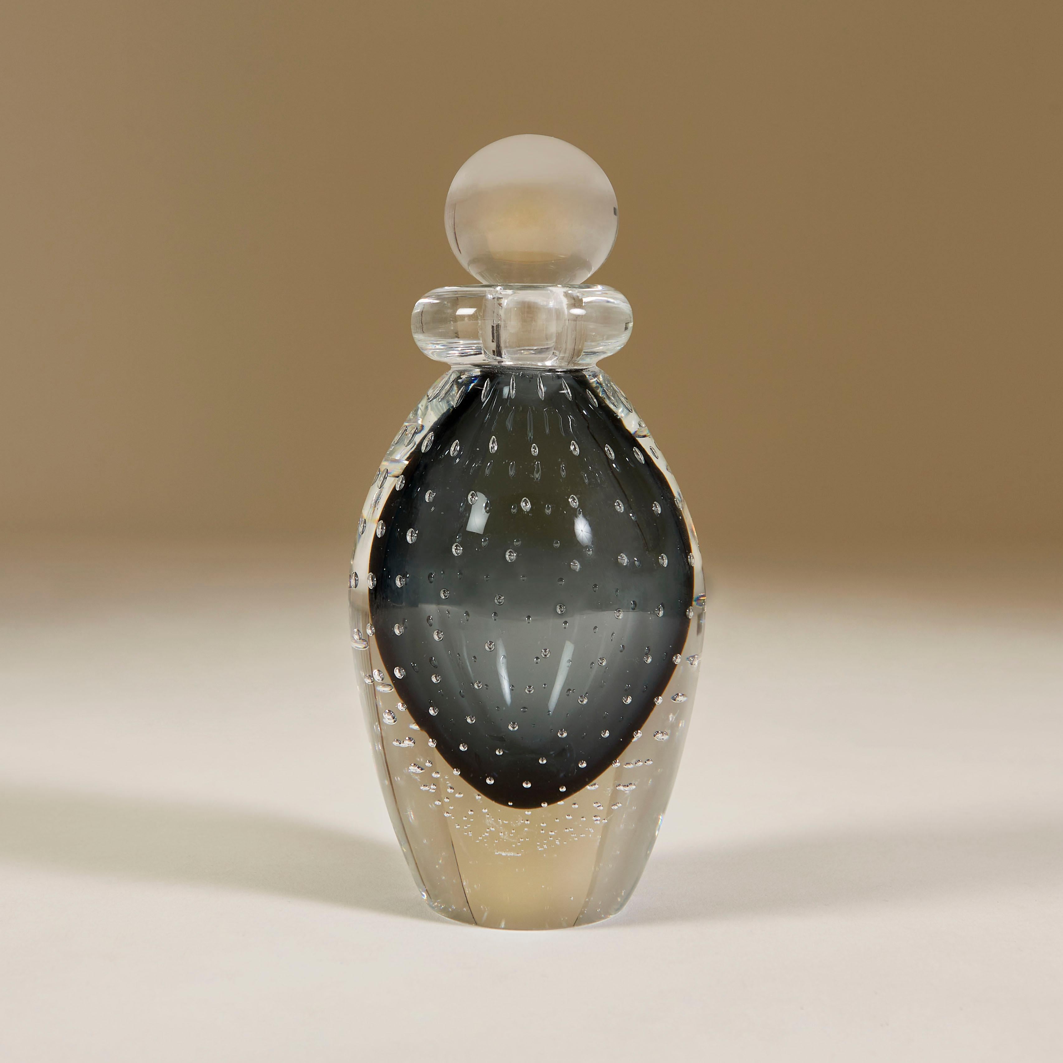 Grey / black red Bullicante tall perfume bottle cased in clear Murano glass with clear glass collar and ball stopper. 
Made famous in the 1930s by Archimede Seguso, the Bullicante controlled bubbles technique involves overlaying several layer of