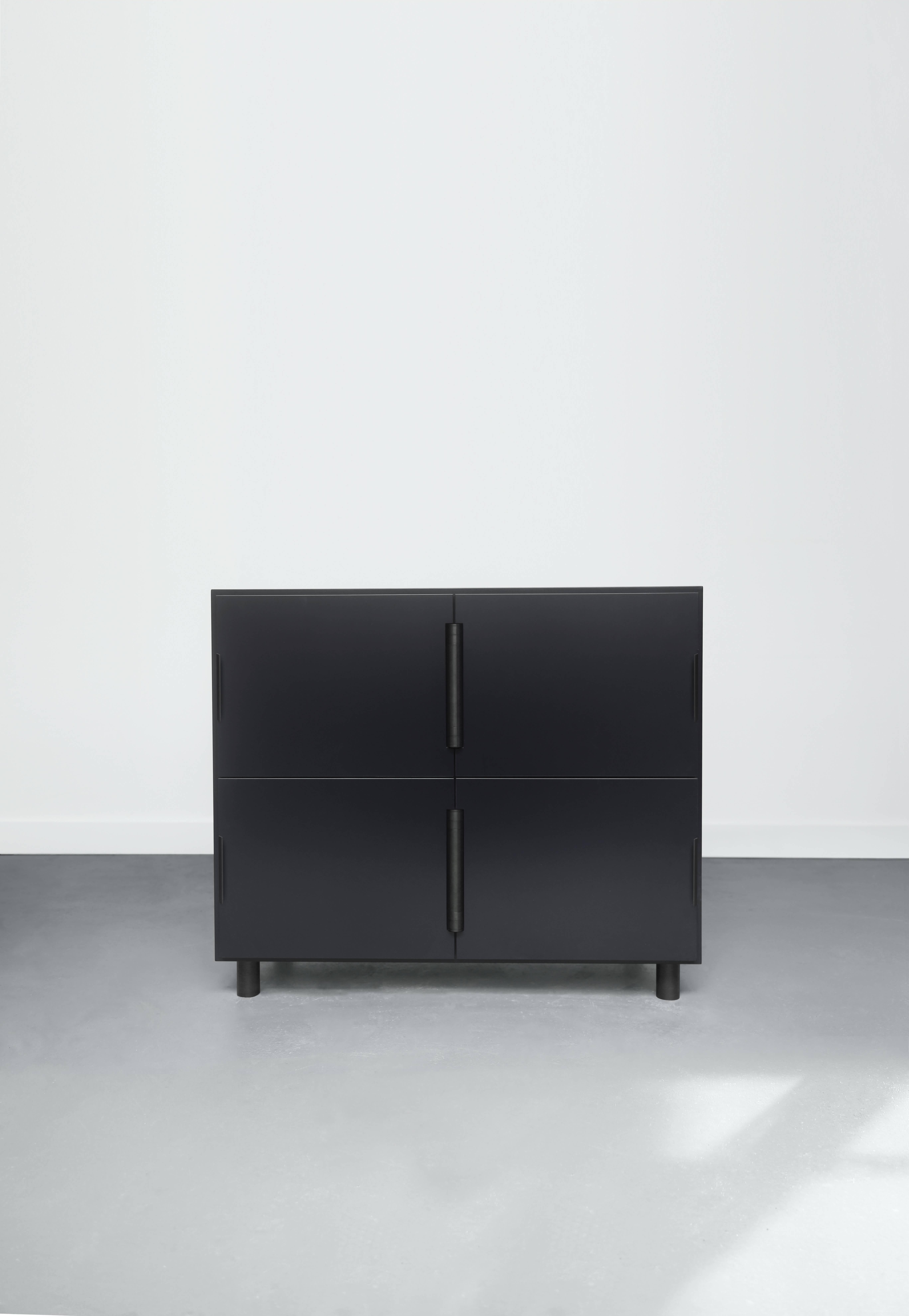 Pictured in Coal (grey), Nocturne is a multi-use storage cabinet with an austere beauty. Its center-hung doors swing inward on a shared hinge. The modern case is matte lacquered wood, with a sophisticated blackened steel hardware set. 

Additional