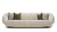 Contemporary Gulman Sofa with Sleek Curved Silhouette And Brushed Brass Base