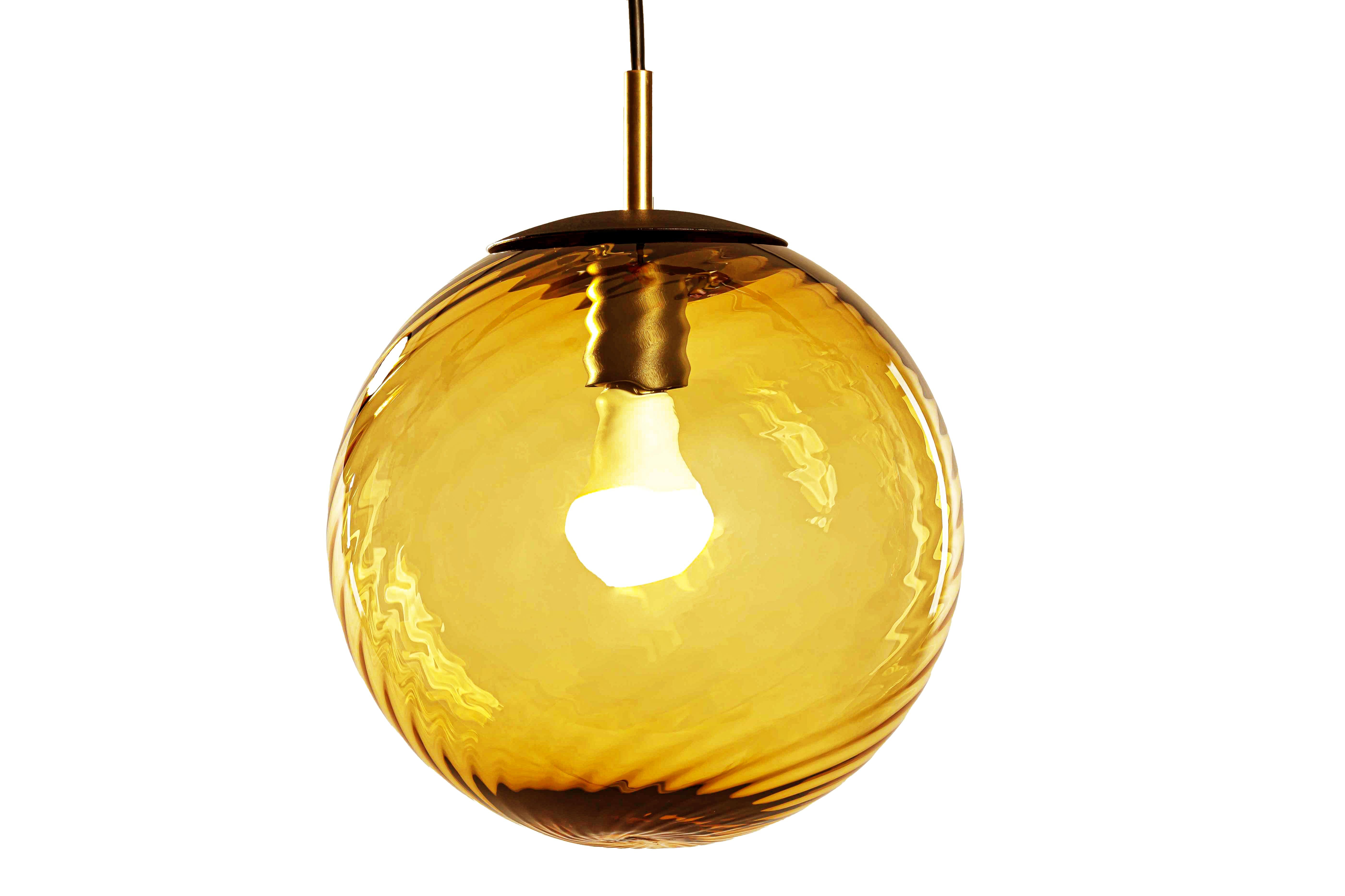 The new Astro range from Luminosa, a range of architectural glass lamps in transparent amber with optical twist. Classical yet modern these little pearls suit just about every environment. Cord-set and matching canopy are powder-coated black with