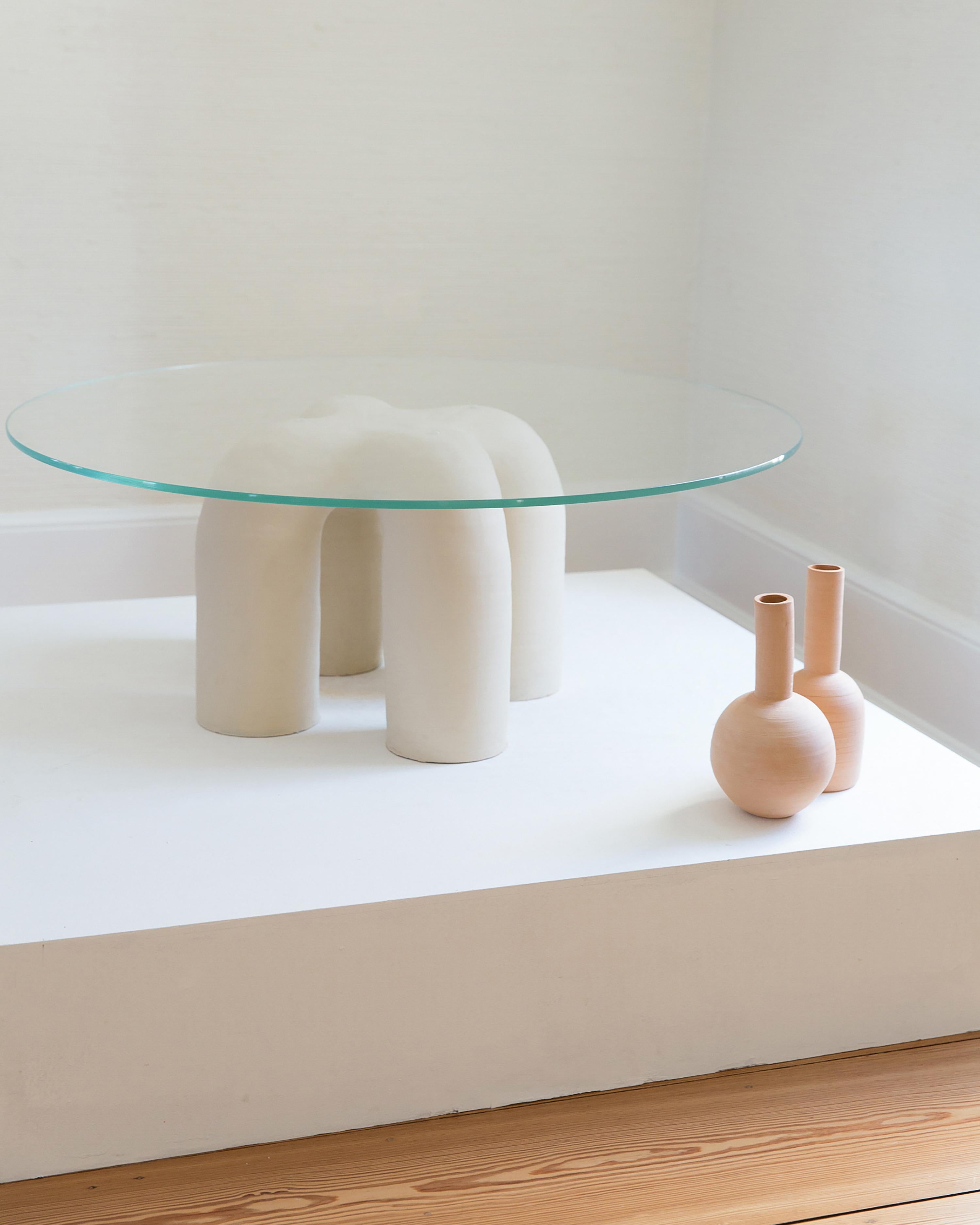 This organic shaped table includes a hand-built ceramic housing available in several glaze colors, with a 1/2