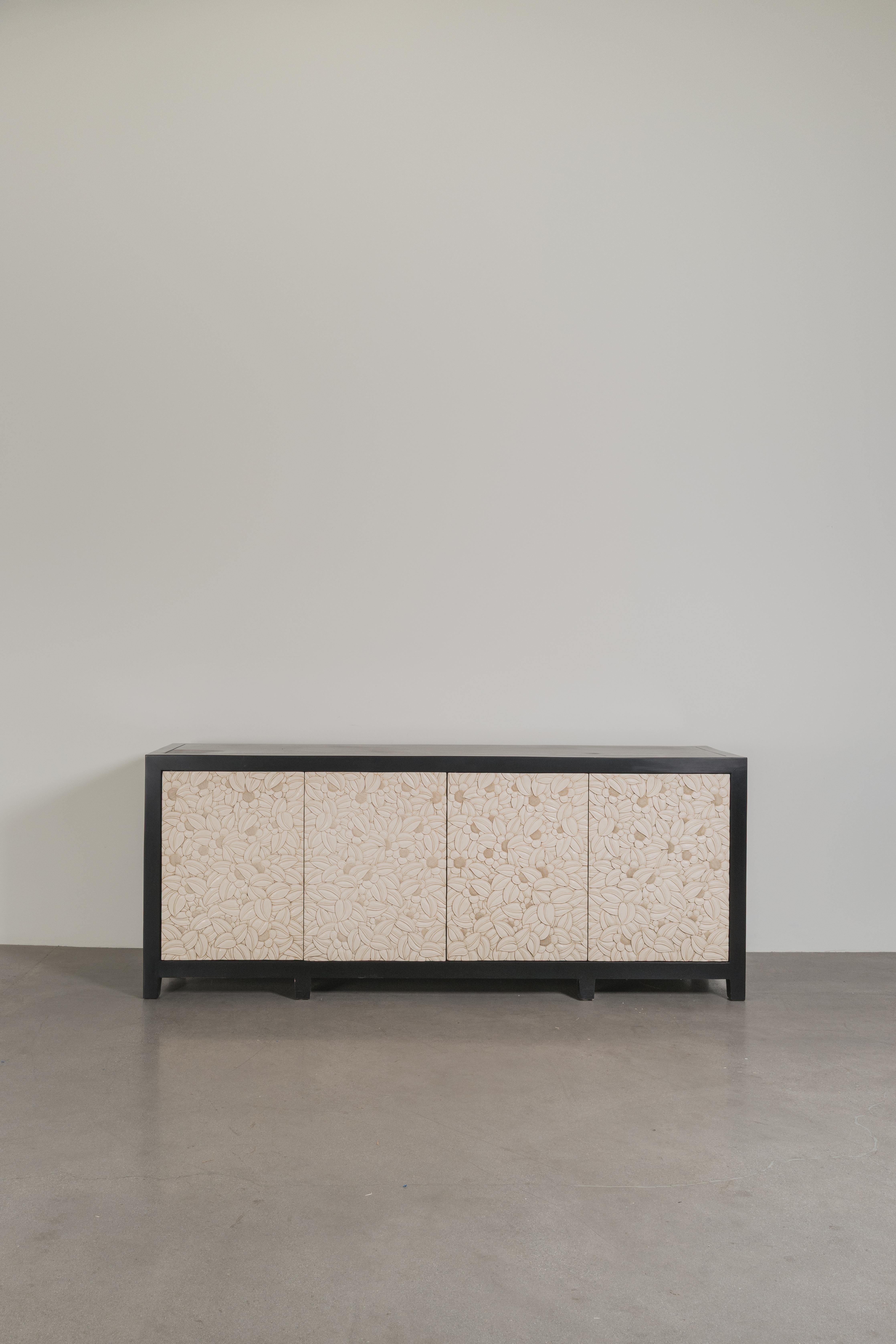 Floral Design Buffet
4 Doors
Cream Lacquer
Hand Carved 
Lacquered Wood
Push Touch Latch 
4 drawers with Copper Handles
2 Tier Removable Shelves
Limited Edition
Contemporary
Each piece is individually crafted and is unique. 

Lacquer is a laborious