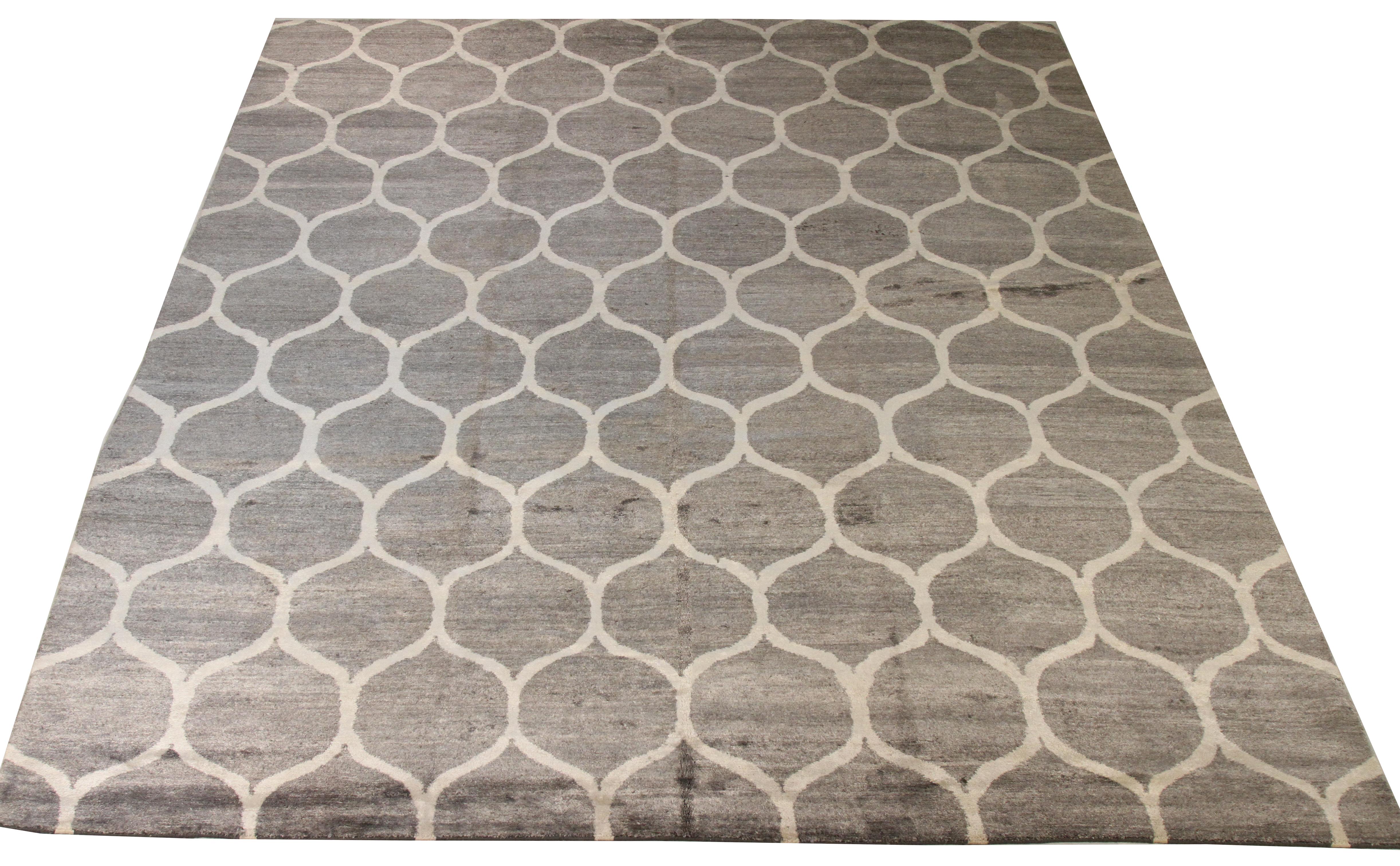 Contemporary Nepalese rug hand-knotted from a mix of fine wool, silk and colored with all-natural vegetable dyes that are safe for people and pets. It features a modern honeycomb pattern infused with abstract elements. 

This area rug has a