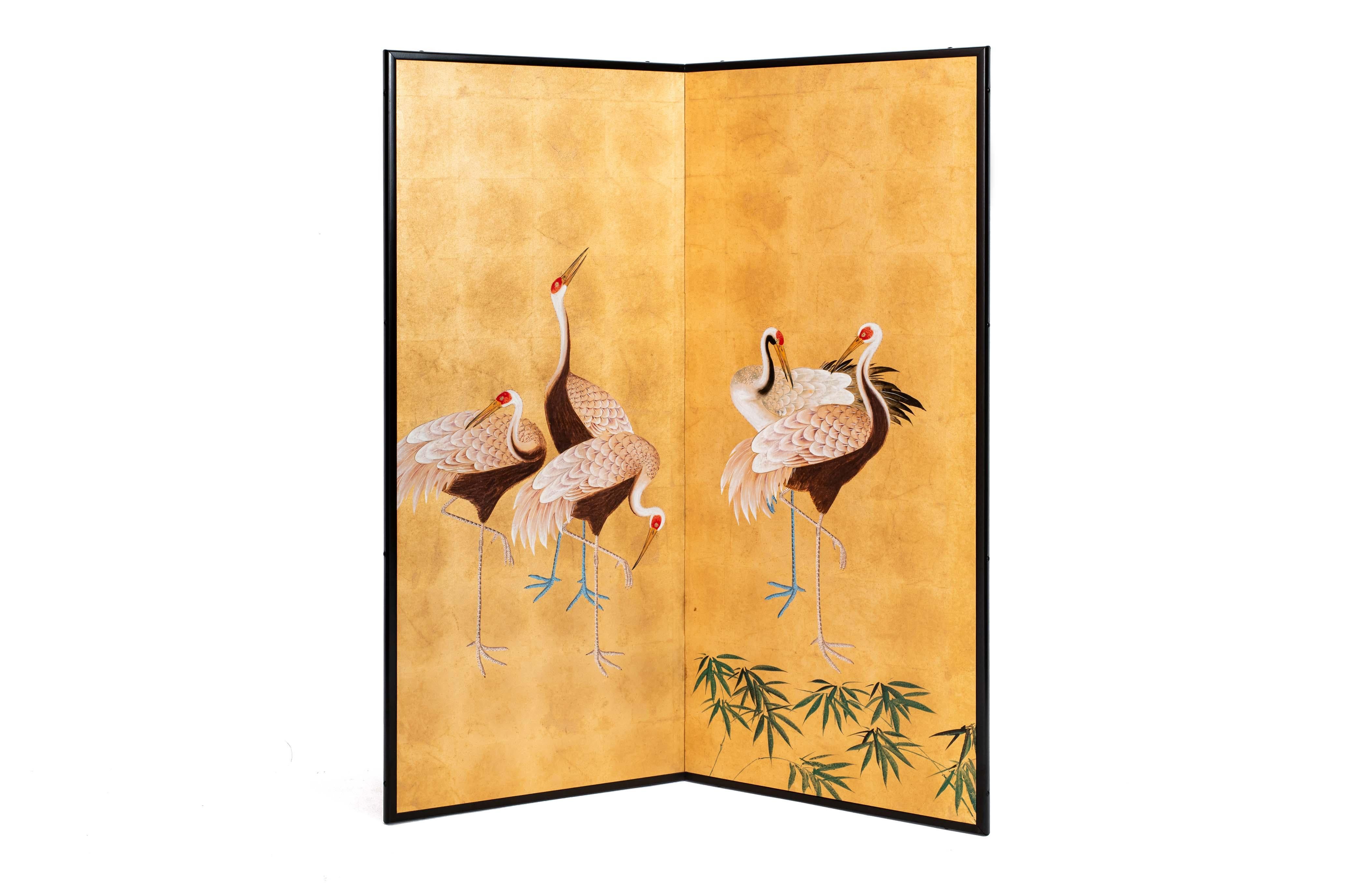 The standing cranes painting of this two-panel screen is hand-painted in watercolor, on squares of gold leaf which are applied by hand to the paper base over carefully jointed wooden lattice frames. Lacquer rails are then applied to the perimeter to