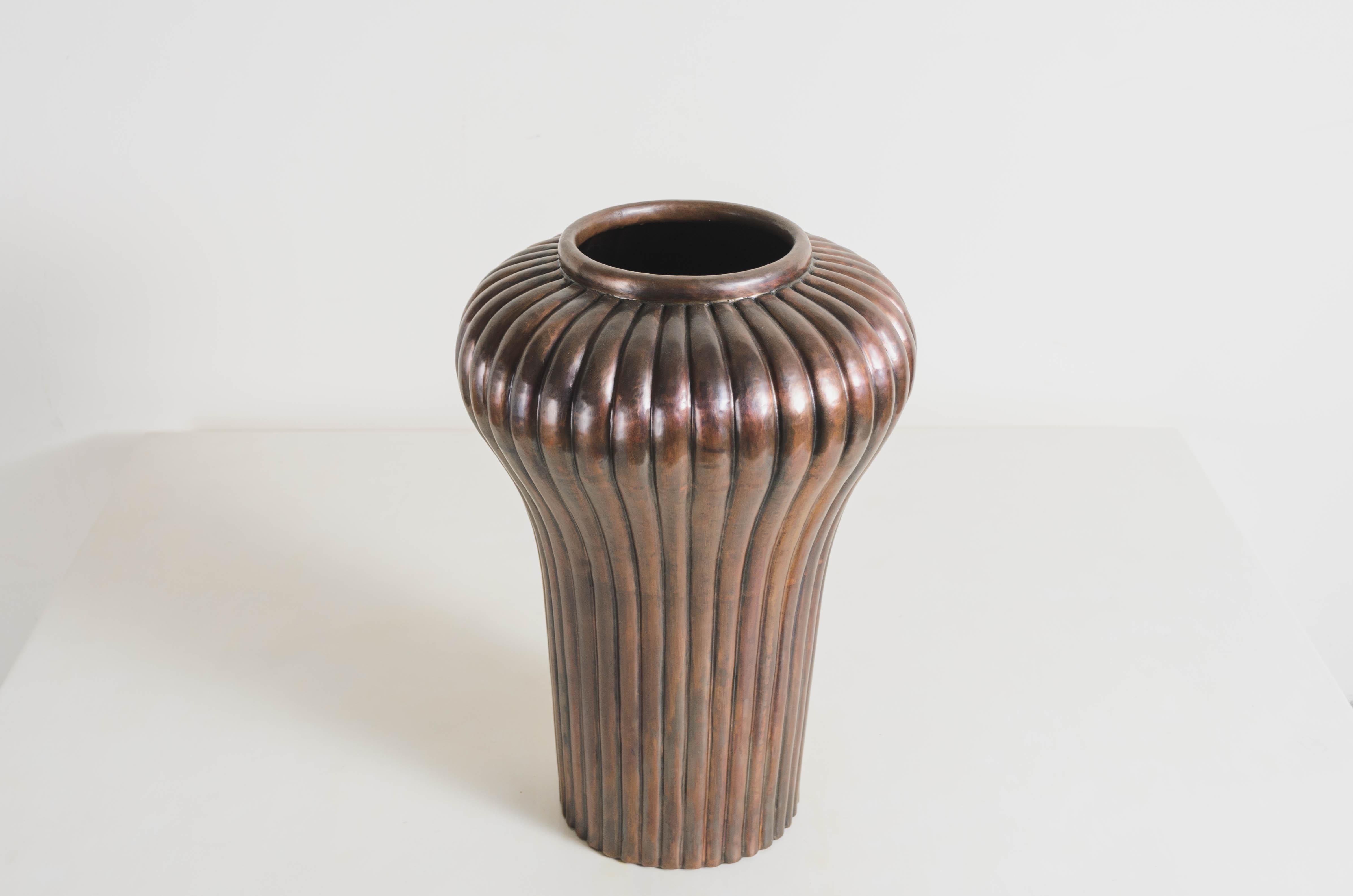Ribbed Jar
Antique Copper
Hand Repoussé
Limited Edition
Each piece is individually crafted and is unique. 

Repoussé is the traditional art of hand-hammering decorative relief onto sheet metal. The technique originated around 800 BC between