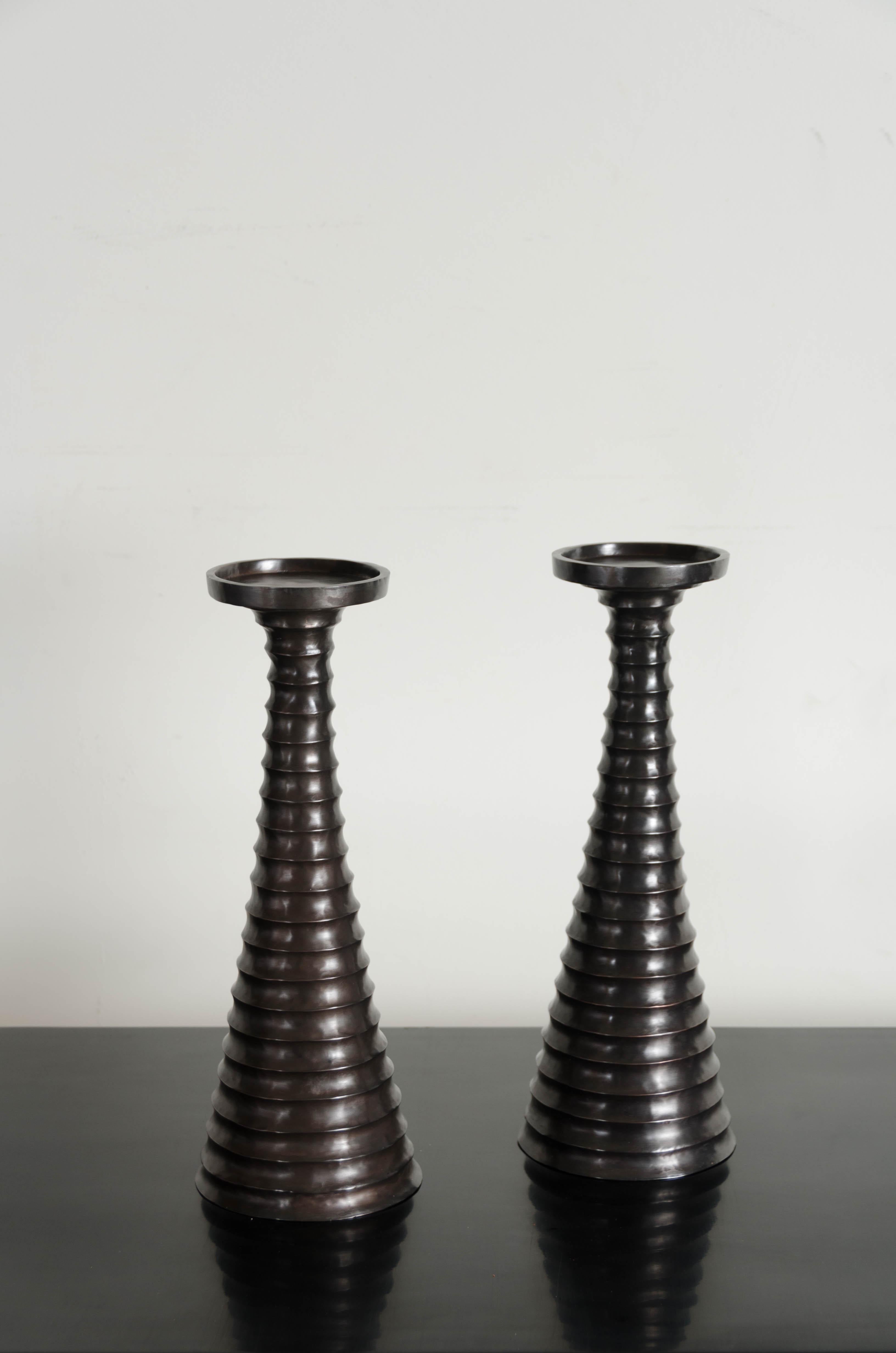Tang candlestand
Black copper
Hand repoussé
Contemporary 
Limited edition
Each piece is individually crafted and is unique. 

Repoussé is the traditional art of hand-hammering decorative relief onto sheet metal. The technique originated