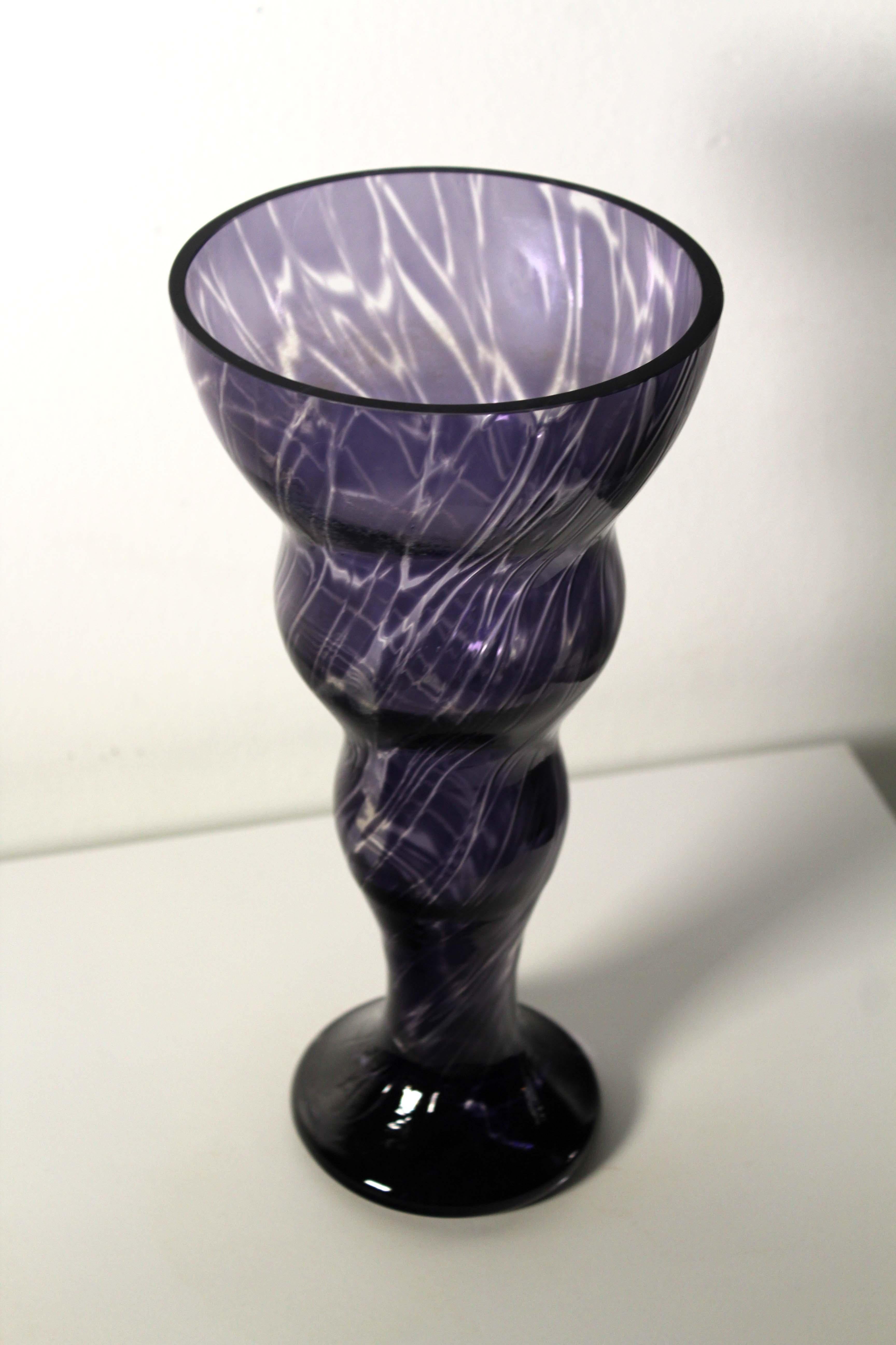 A marvelous handblown glass vase. An indigo color with a swirl design. A wonderful accent piece in a modern or contemporary home. Dimensions: 10.25” height x 5” diameter. In very good condition.
  