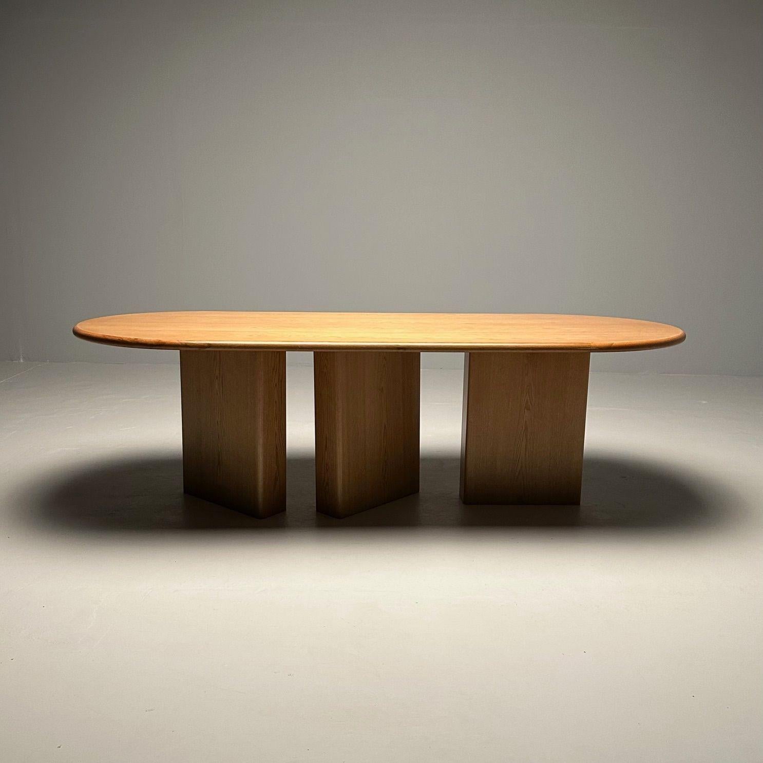 Contemporary Handcrafted Oval Dining Table, Solid Oak, Modern Pedestal Base

Modern oval and narrow dining or kitchen table in solid stained oak wood. The rounded and stained solid oak table top sits on three playfully arranged solid wooden pedestal