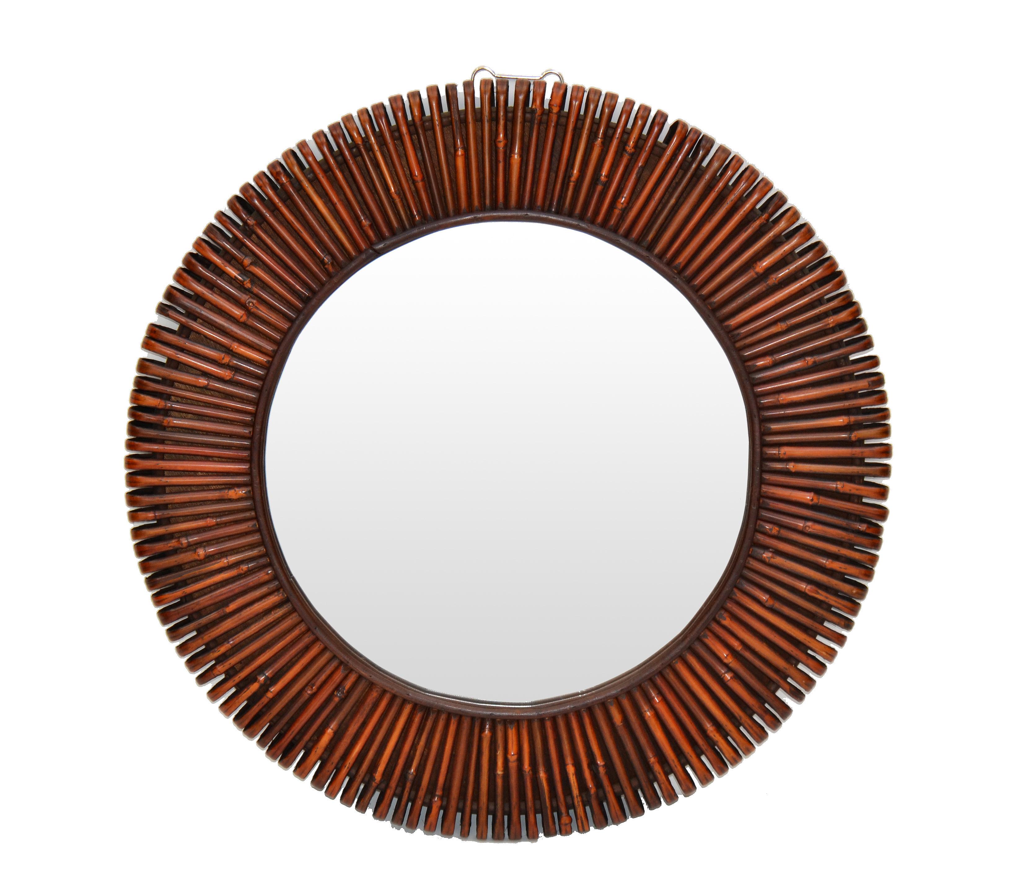 Beautiful modern round handcrafted bent rattan wall mirror.
The back is solid wood with a secure hanging construction. 
This mirror is super fashionable.
Mirror size: 16.25 inches diameter.