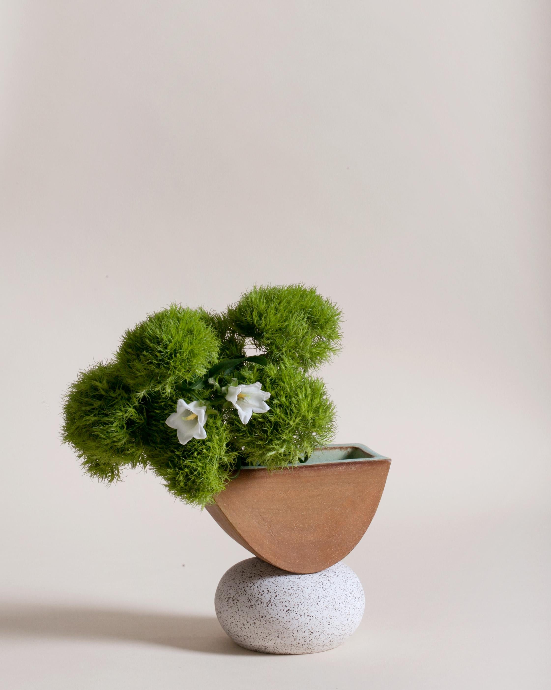 One of a kind ceramic Ash vase in red clay with white speckled base, copper green glaze interior. The vase is comprised of two different clay bodies and features a raw, unglazed ceramic surface to highlight the texture of natural clay. The ceramic