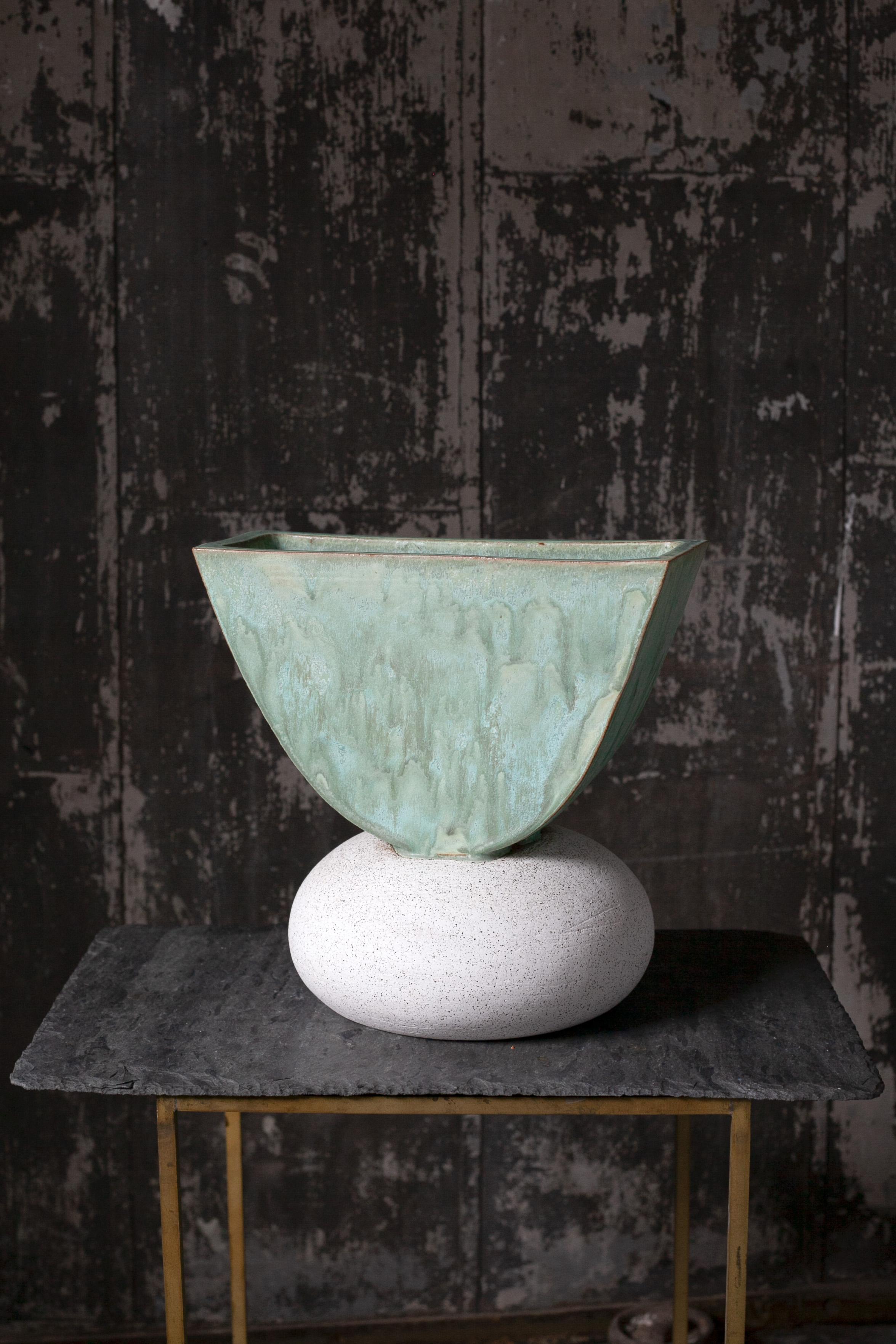 One of a kind ceramic ash vase. The vase is comprised of two different clay bodies and is glazed with a coppery green glaze on the top contrasting a speckled matte white bottom. Assembled by hand, the top of the piece is hand built and the bottom