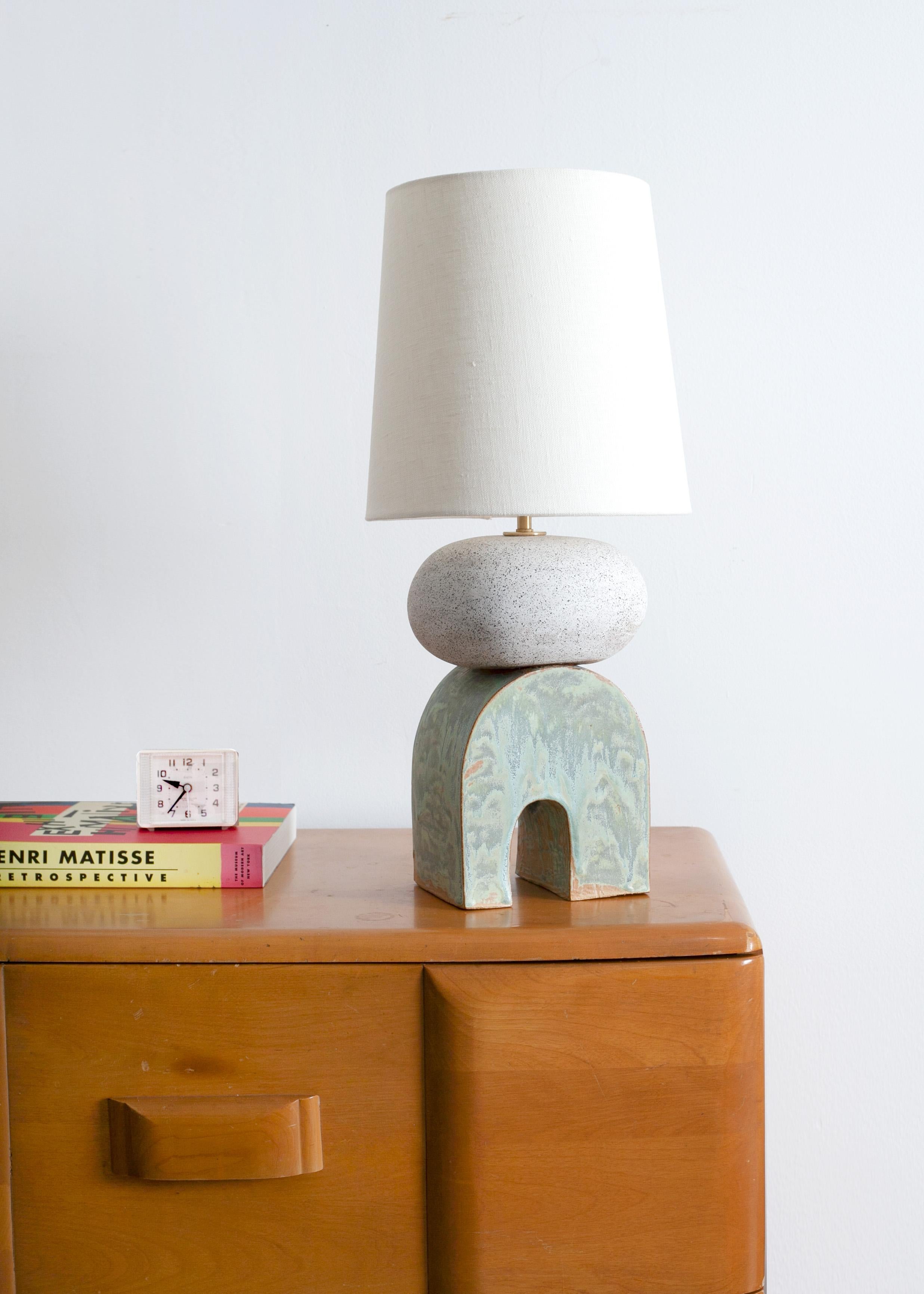 One of a kind ceramic lamp, thrown on the potters wheel and assembled by hand. The lamp base is comprised of two different clay bodies and features a coppery green handmade glaze in contrast to a speckled white matte globe . This piece was inspired