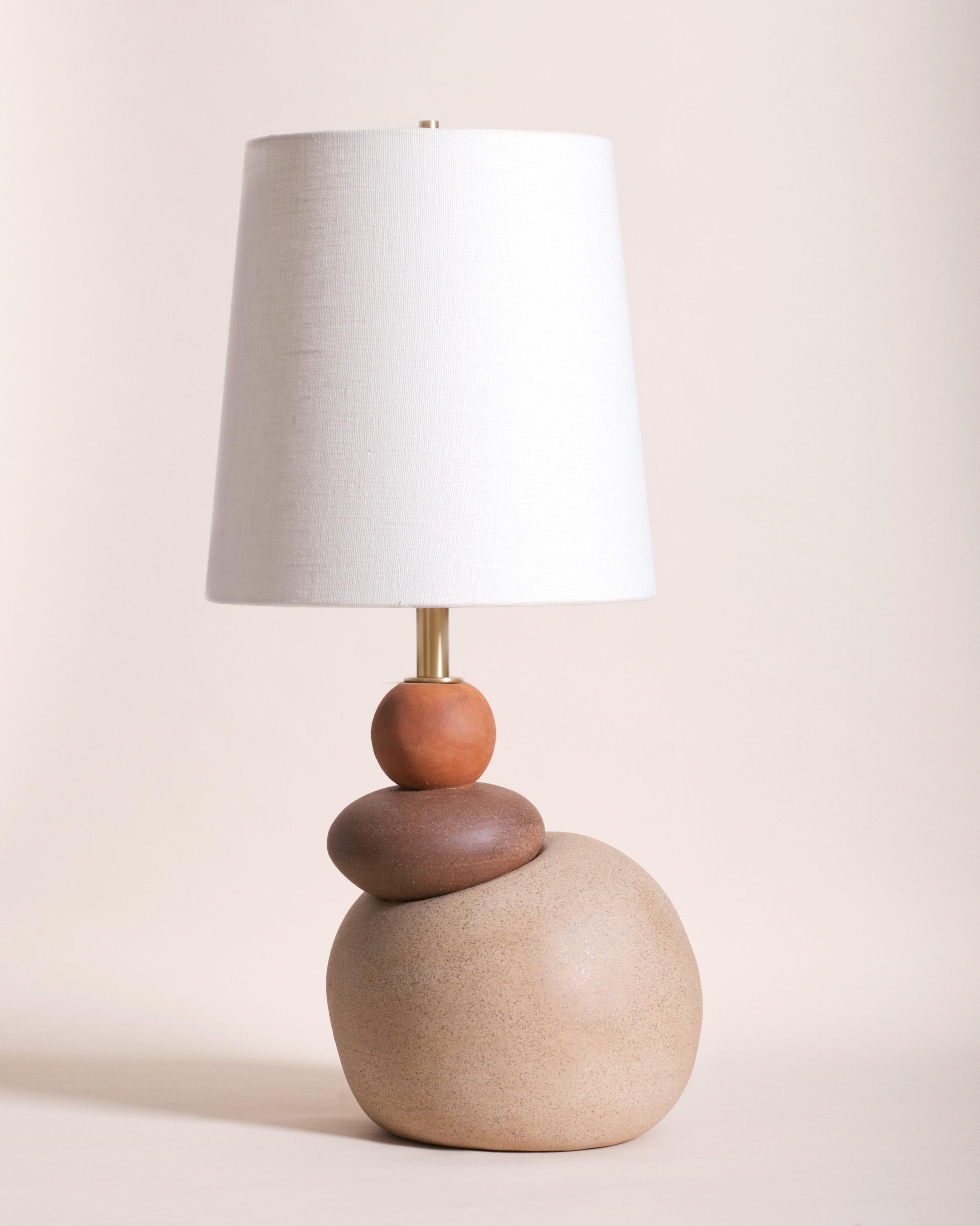 One of a kind ceramic lamp, thrown on the potters wheel and assembled by hand. The lamp base is comprised of three different clay bodies and features a raw, unglazed ceramic surface to highlight the texture of natural clay. This piece was inspired