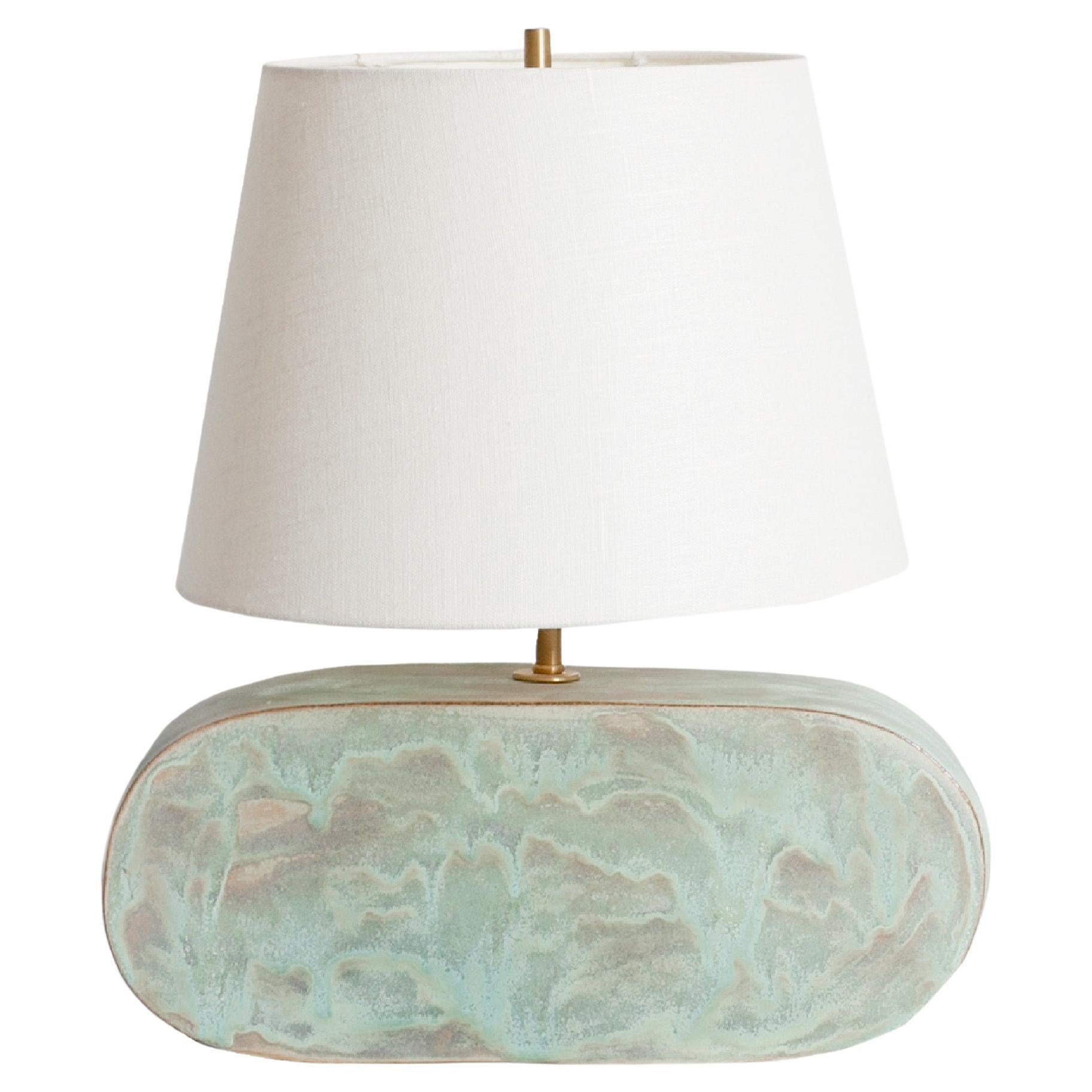 One of a kind ceramic lamp, hand built and assembled by hand. The lamp base is made with red clay manufactured regionally to the East Coast with custom made copper green glaze. This piece was inspired by seashells and smooth stones collected from