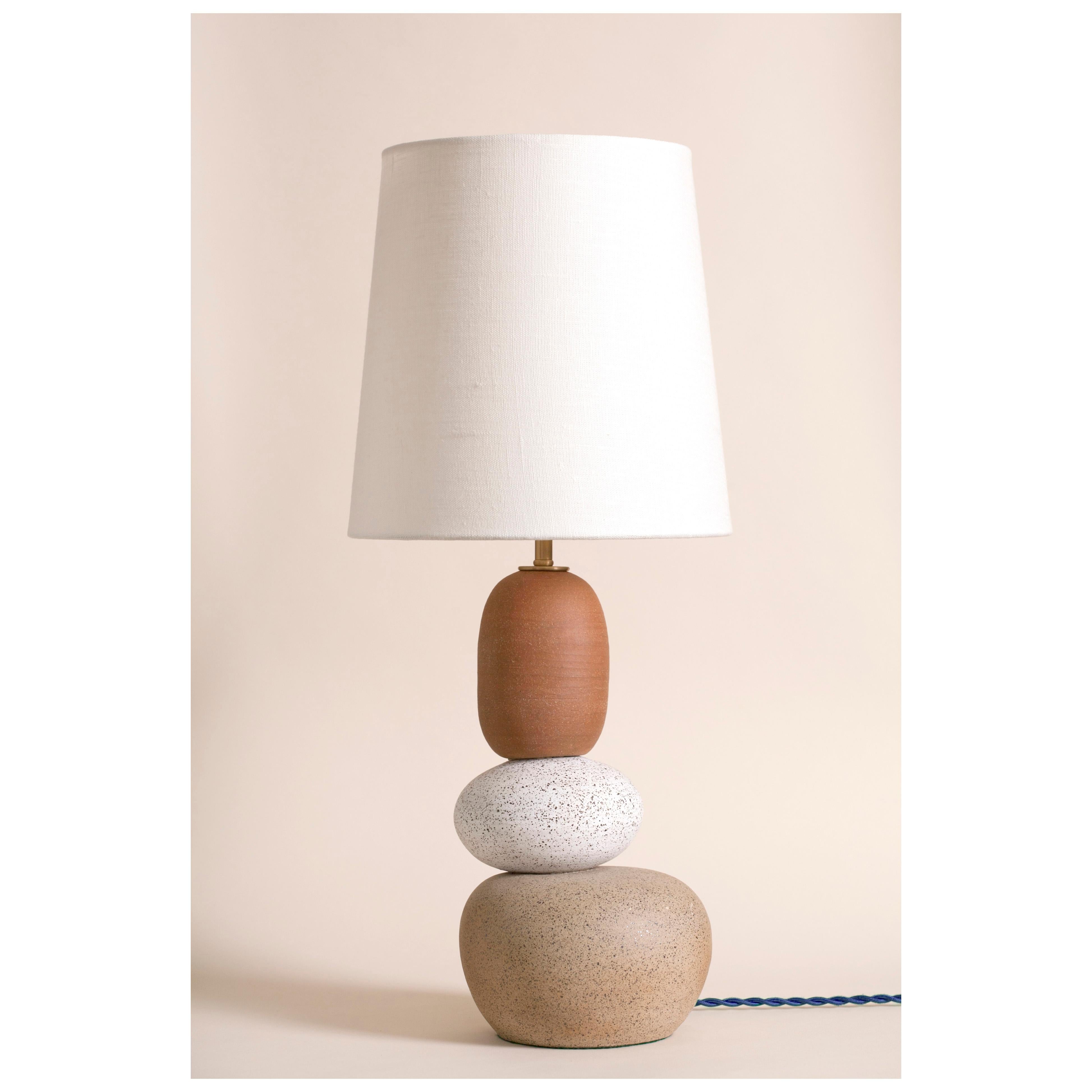 One of a kind ceramic lamp, thrown on the potters wheel and assembled by hand. The lamp base is comprised of two different clay bodies and features a raw, unglazed ceramic surface to highlight the texture of natural clay. This piece was inspired by