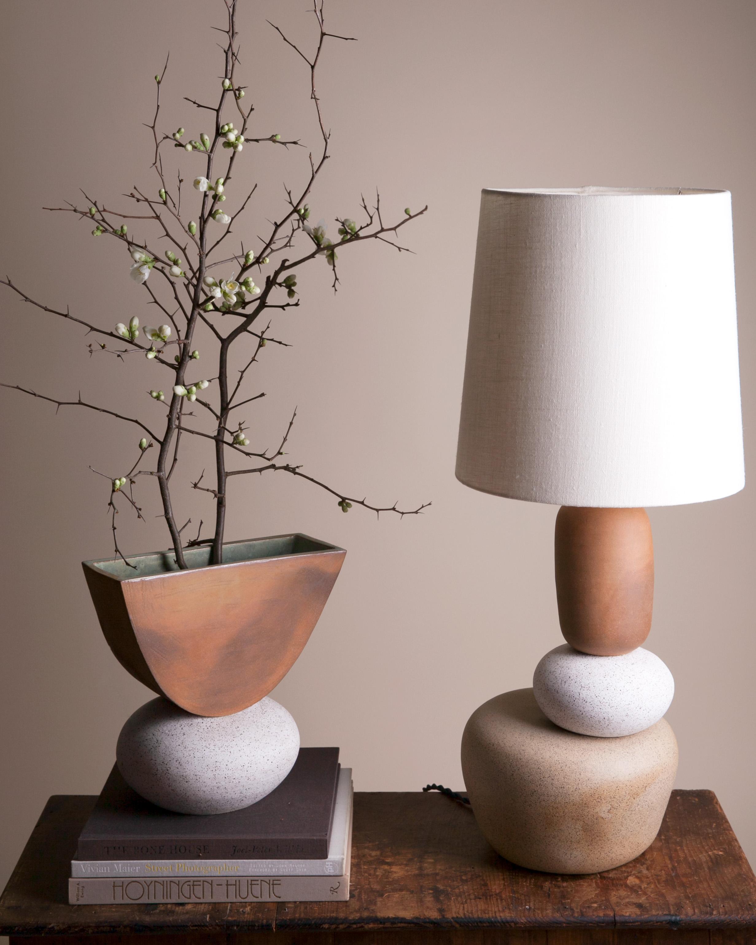 One of a kind ceramic lamp, thrown on the potters wheel and assembled by hand. The lamp base is comprised of two different clay bodies and features a raw, unglazed ceramic surface to highlight the texture of natural clay. This piece was inspired by